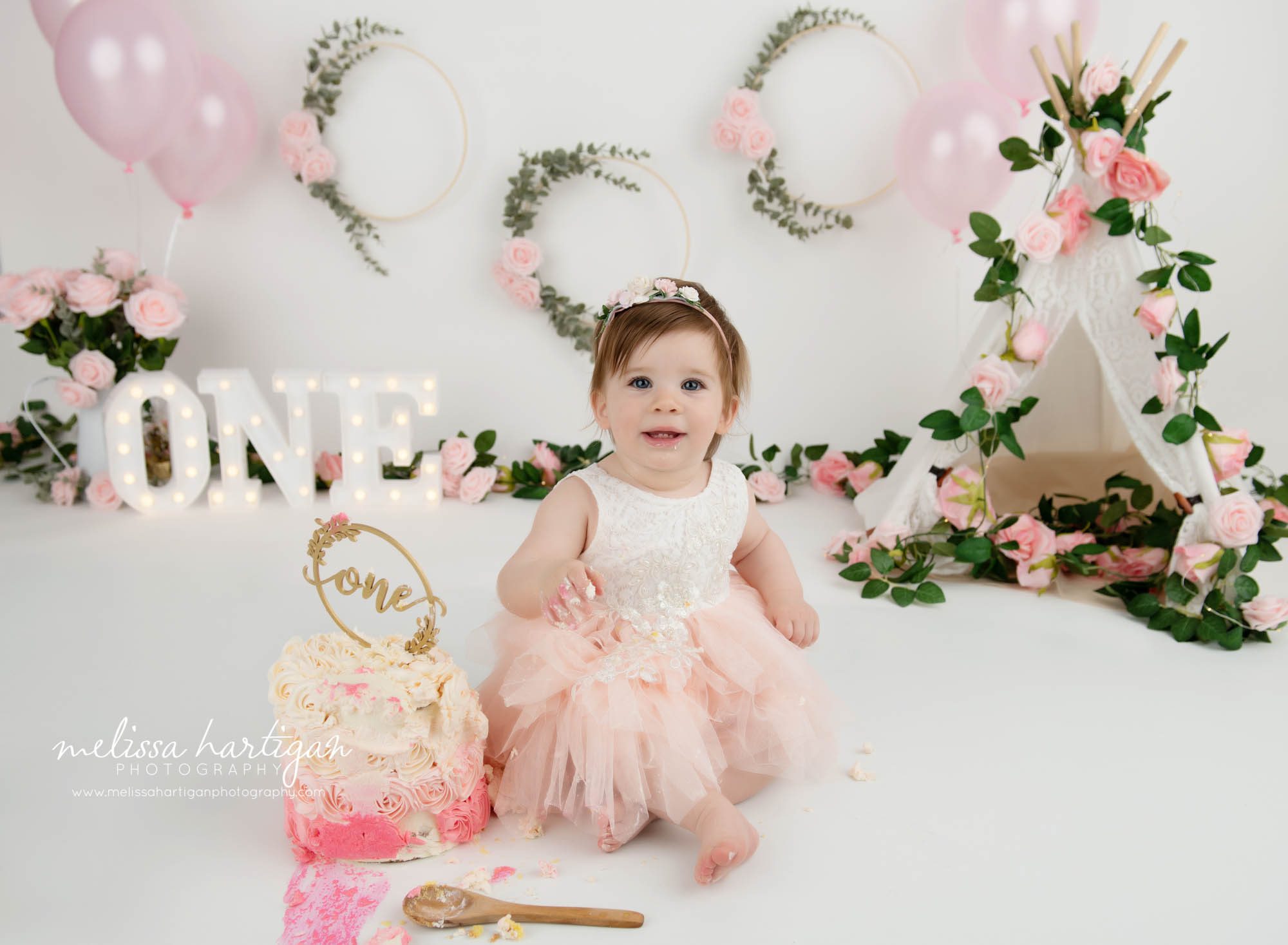 baby girl getting into cake for her cake smash milestone photoshoot connecticut baby photography CT