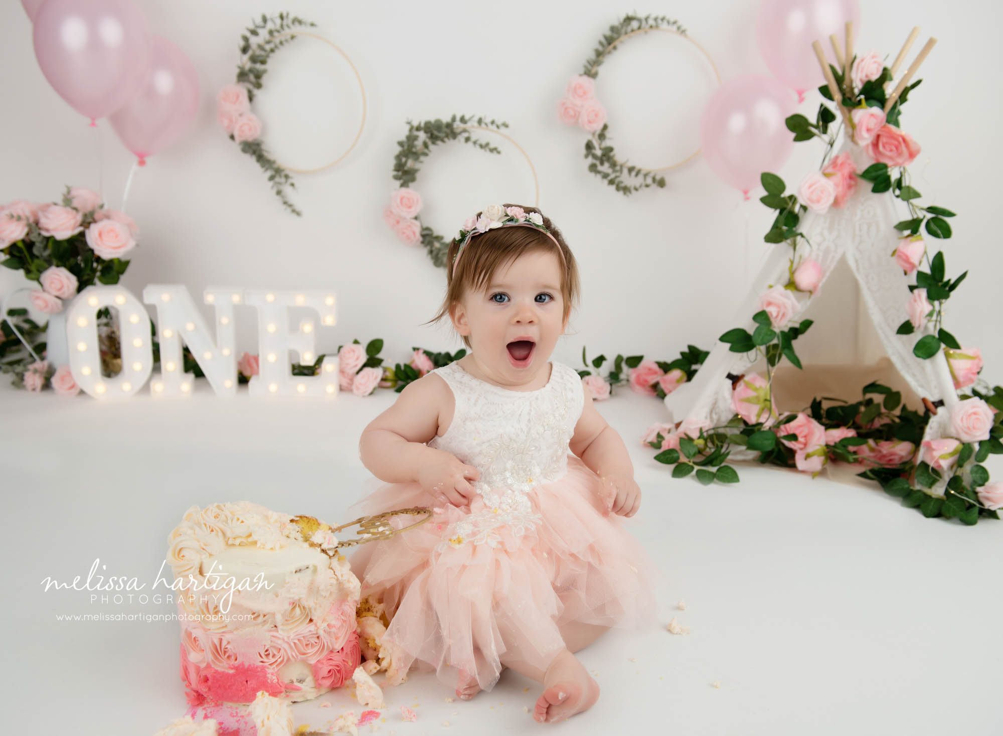 baby girl surprised facial expression during cake smash photography