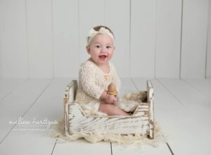 baby girl sitting on bed prop baby milestone photography CT session