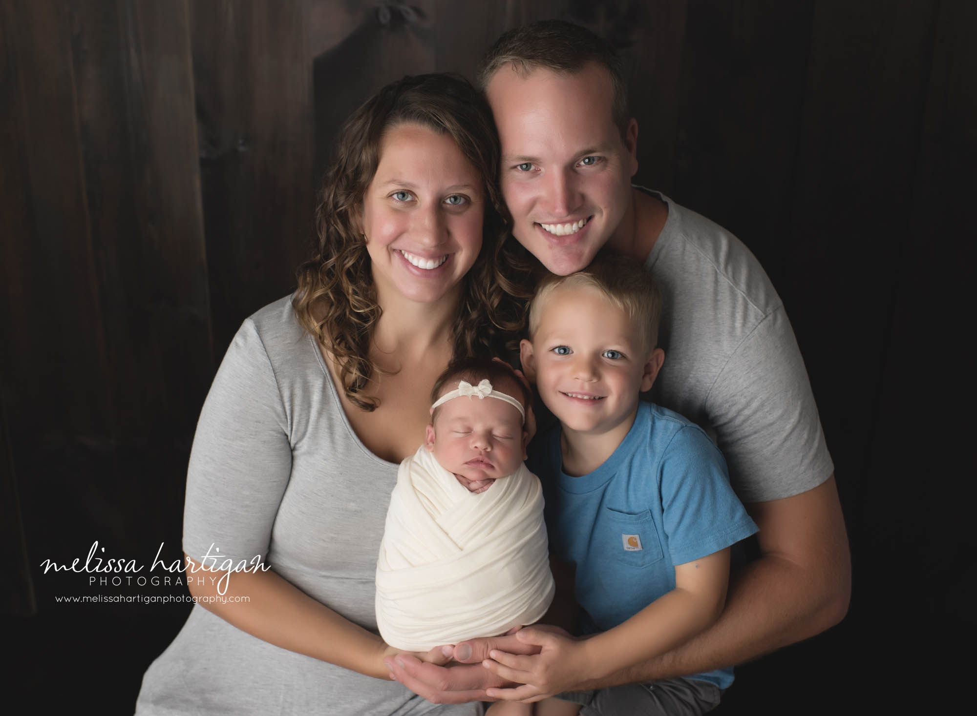 mom dad big brother and newborn daughter family pose CT newborn photographer