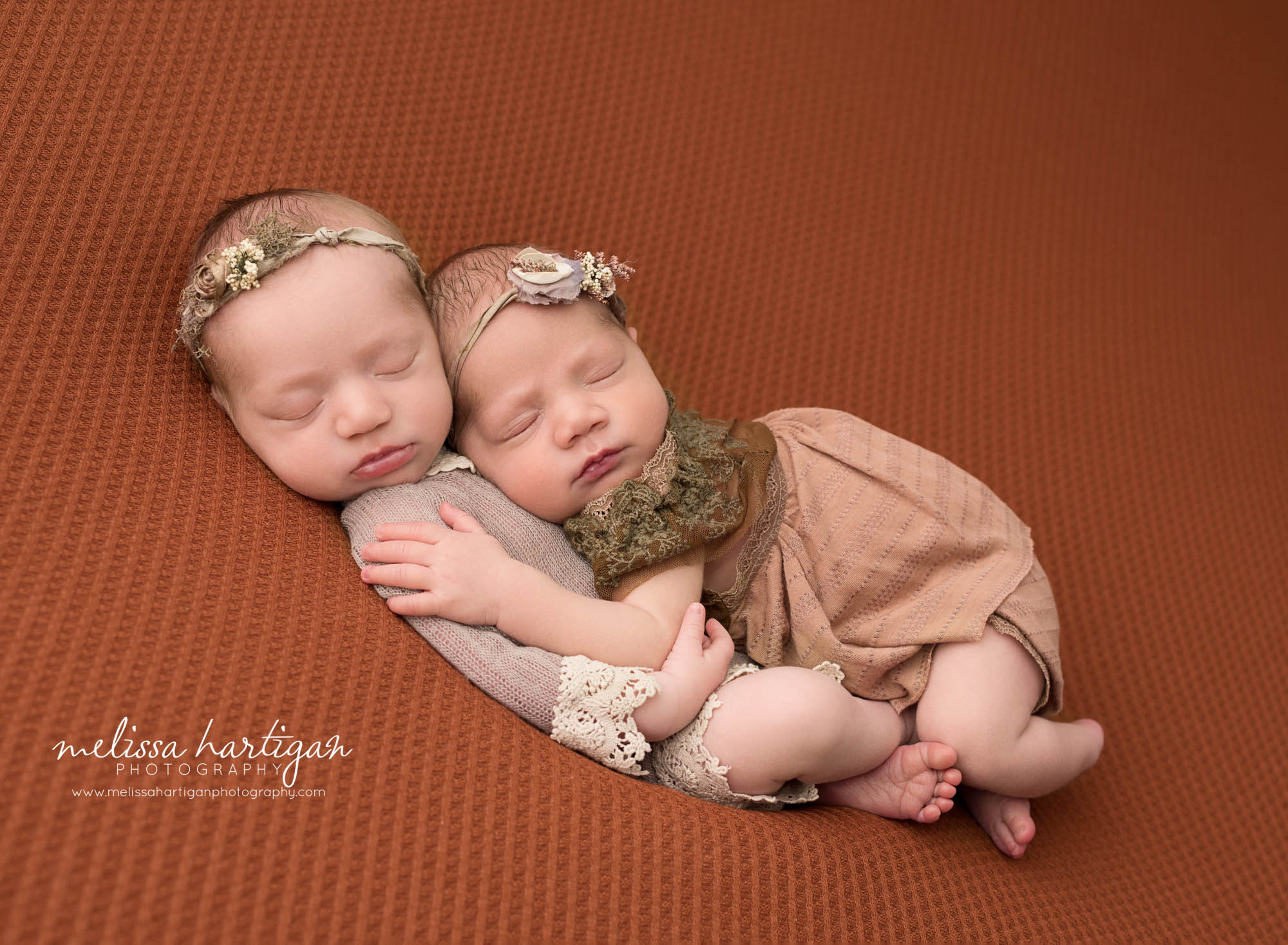 twin newborn baby girls posed together wearing outfits CT newborn Photography