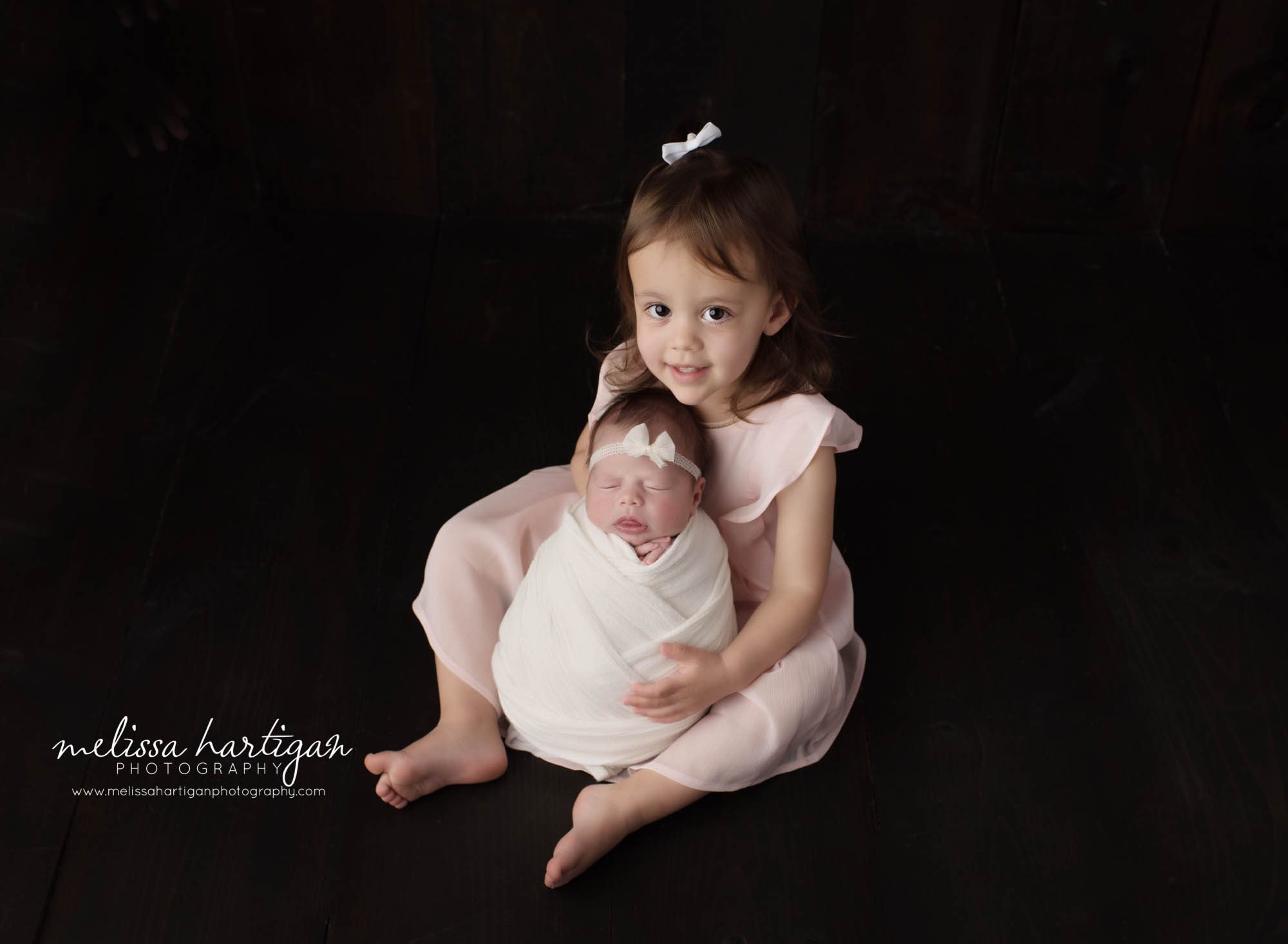 big sister holding newborn baby sister in sibling pose newborn photography Connecticut studio