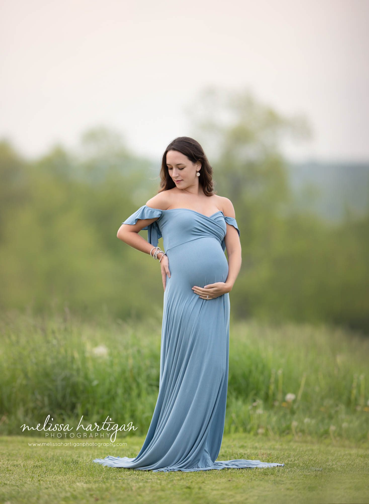 pregnant mom wearing long blue form fitting maternity gown in outdoor maternity session maternity newborn photography CT