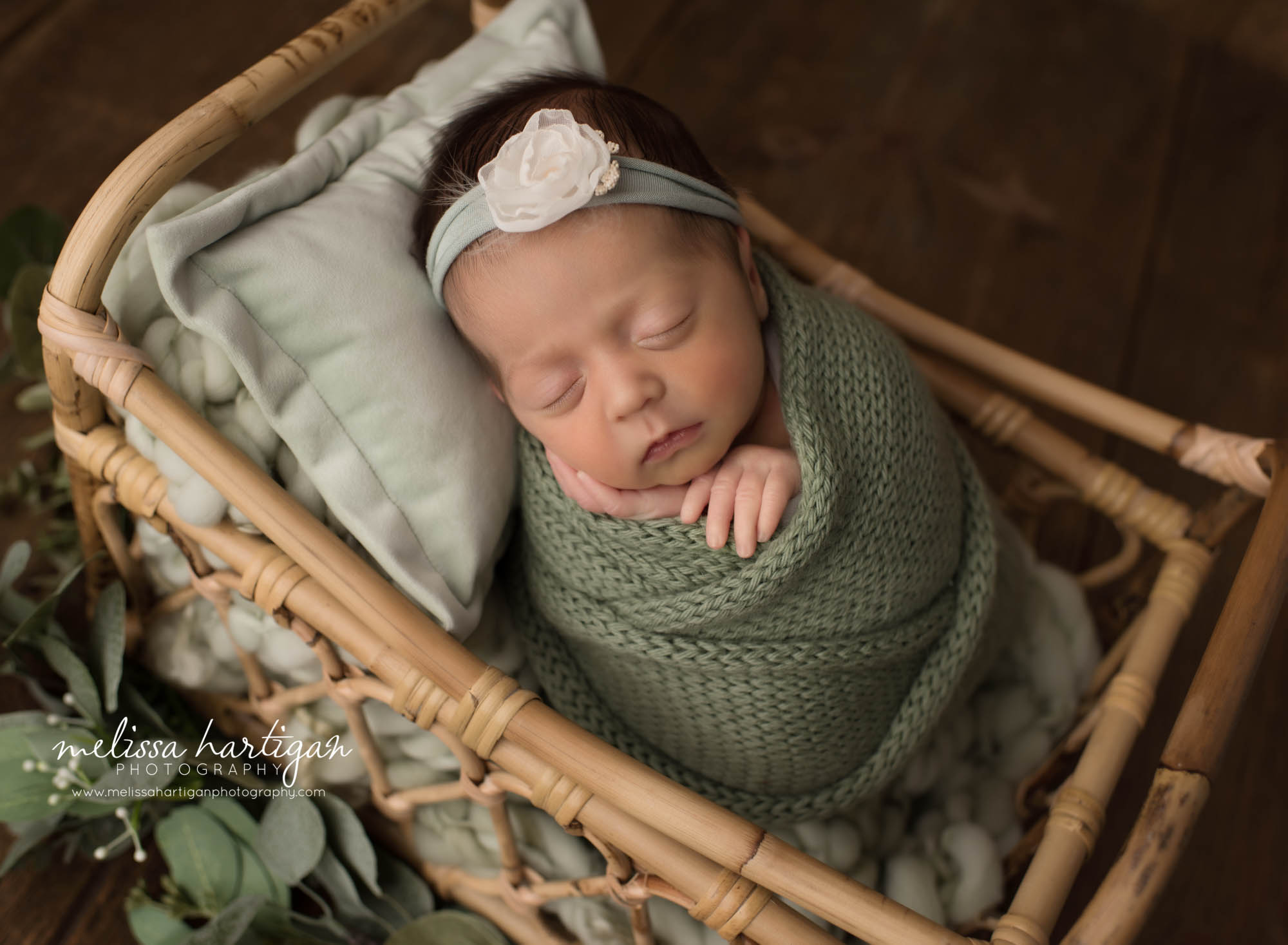 newborn baby girl wrapped in green knitted wrap posed in basket andover CT newborn Photography