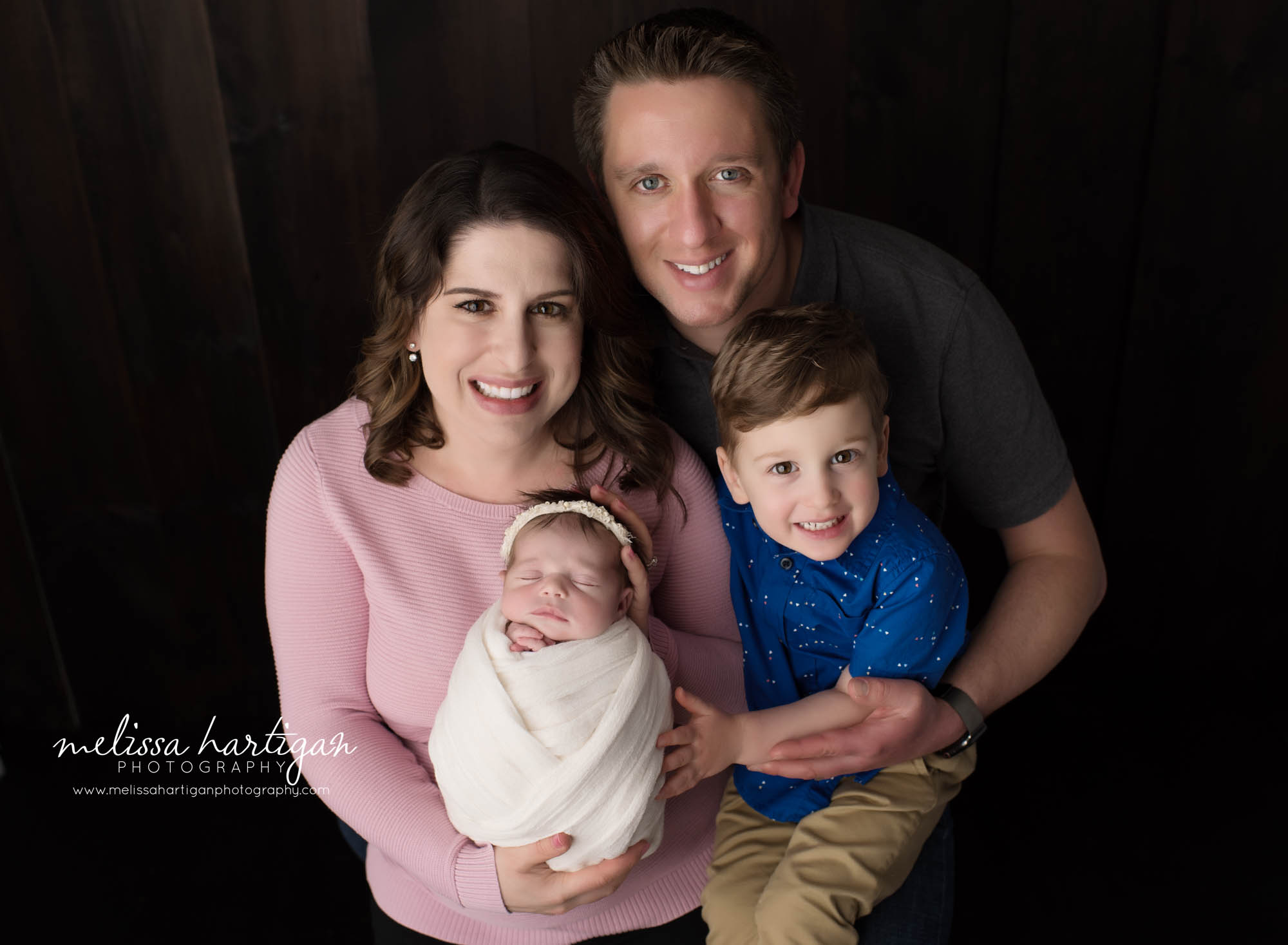 mom dad big brother and newborn baby girl posed family pose CT newborn photography
