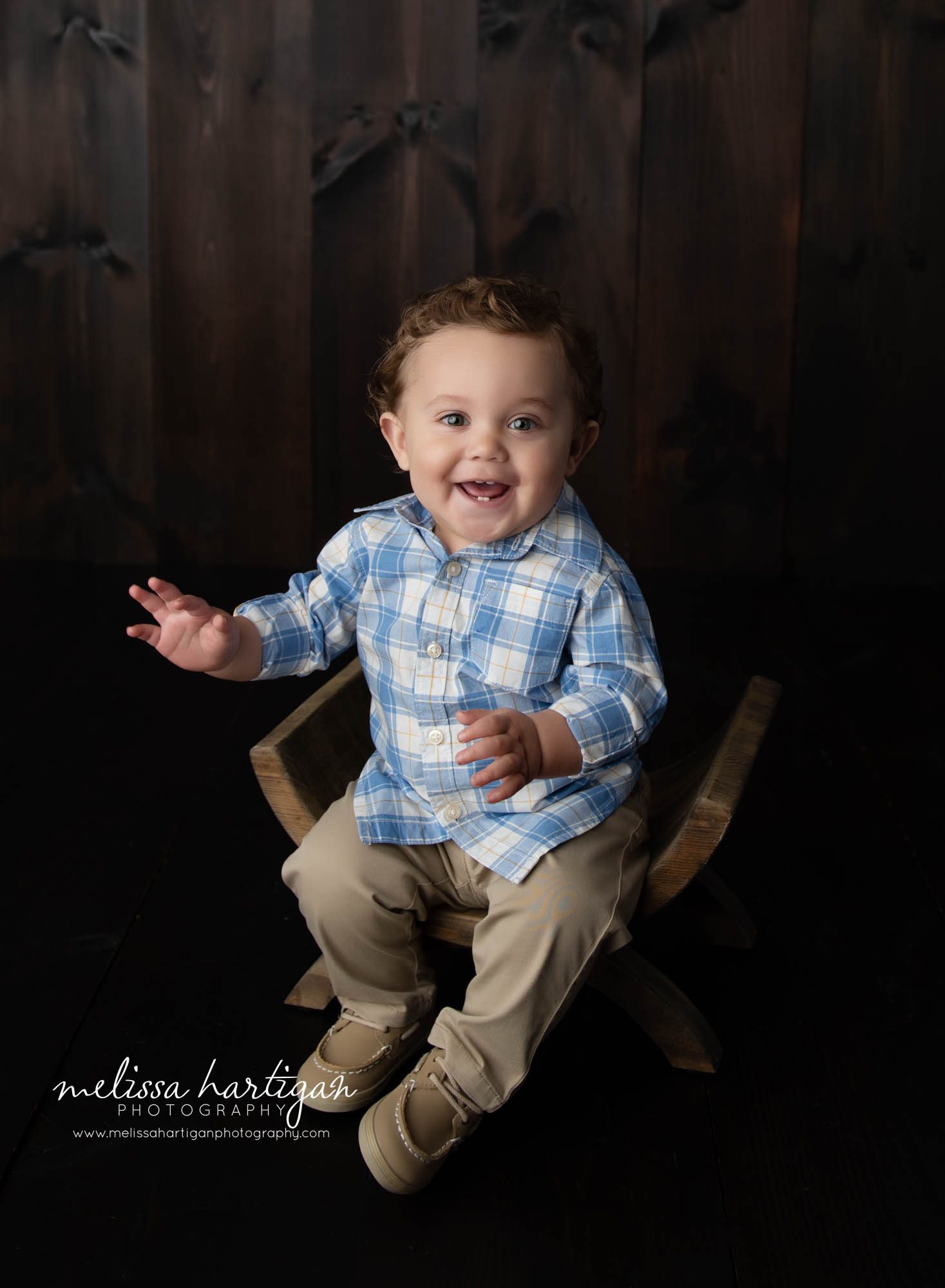 baby boy sitting on curved bench happy smiling Massachusetts baby photography
