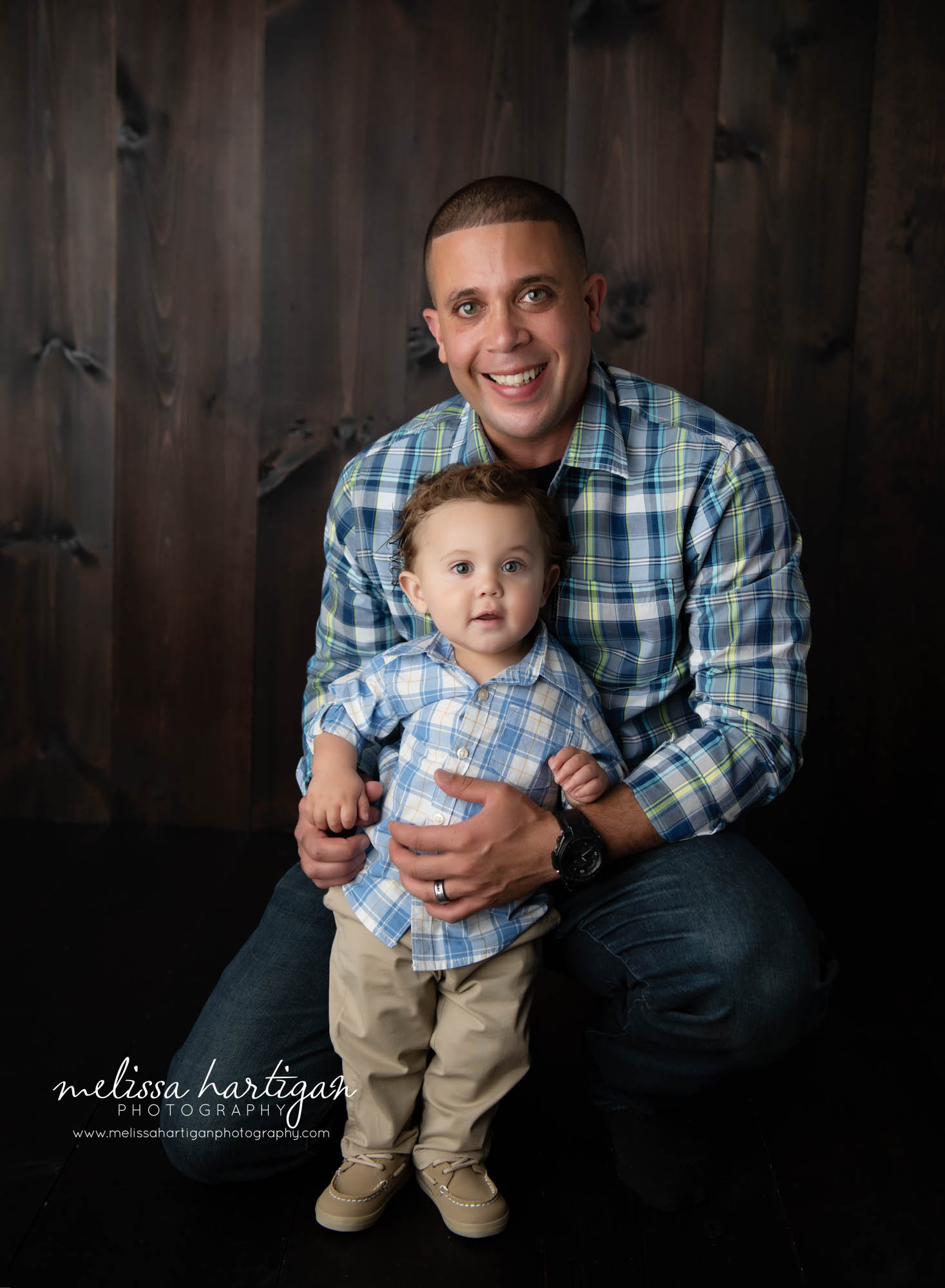 dad holding baby boy in milestone family session
