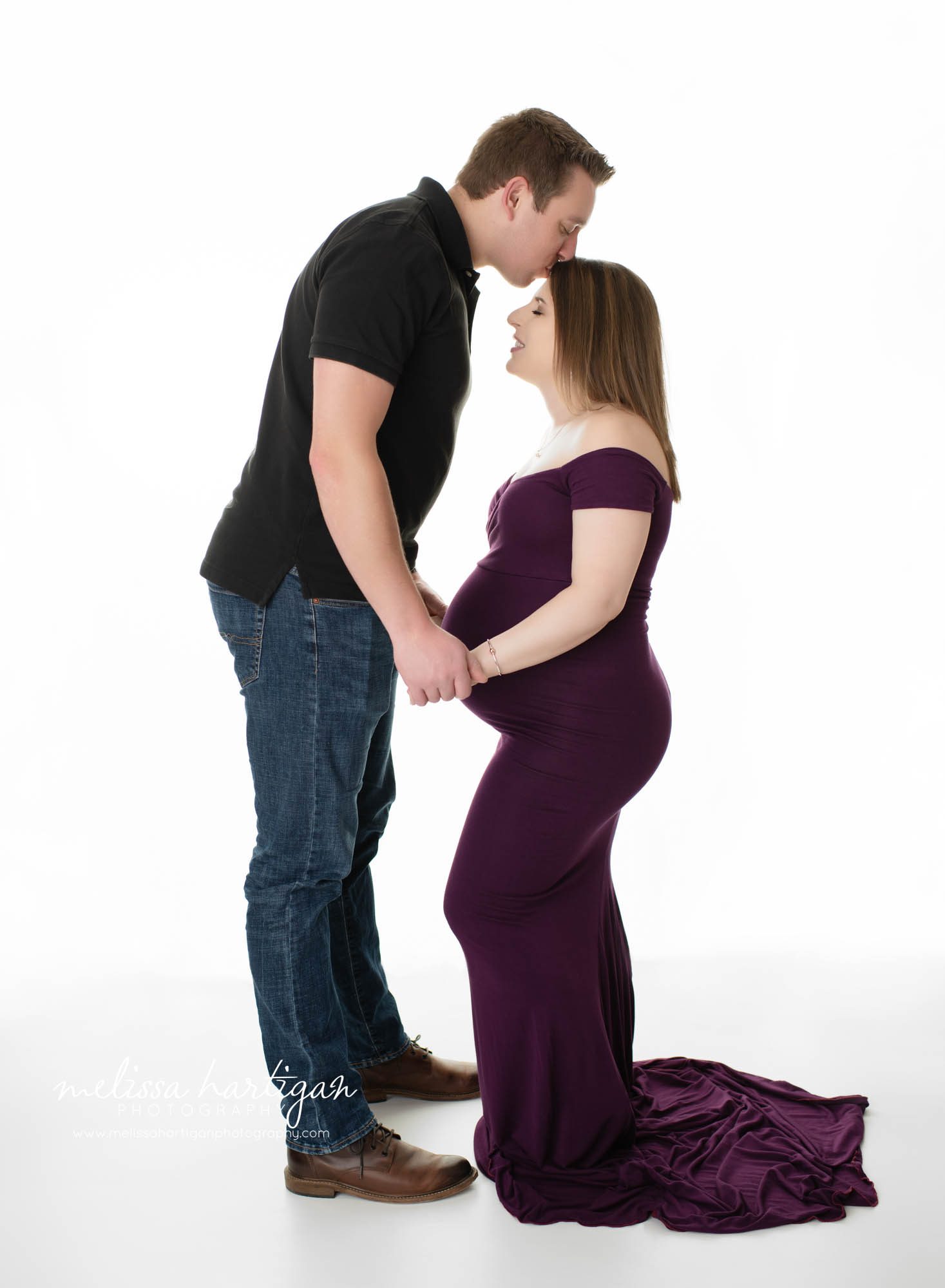 couples maternity photoshoot standing pose dad kissing mom on head photography CT maternity newborn photography