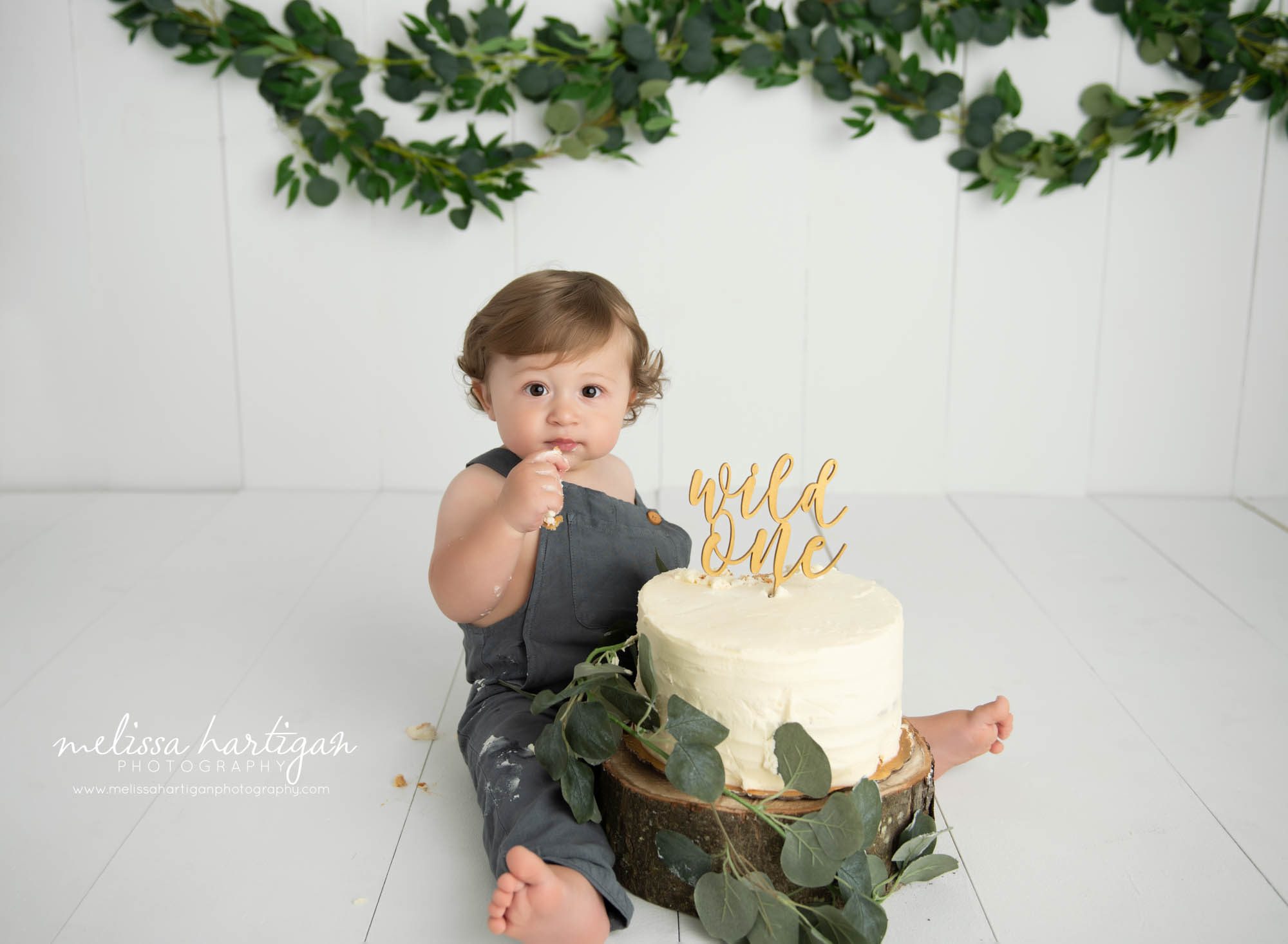 baby boy tasting cake smash cake one year birthday milestone