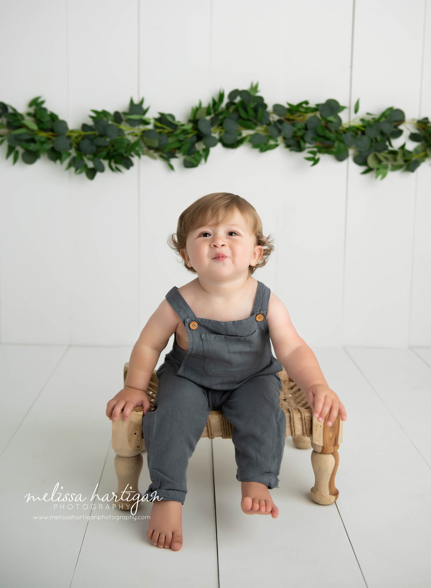 baby boy sitting on bench making kissy face CT baby photography