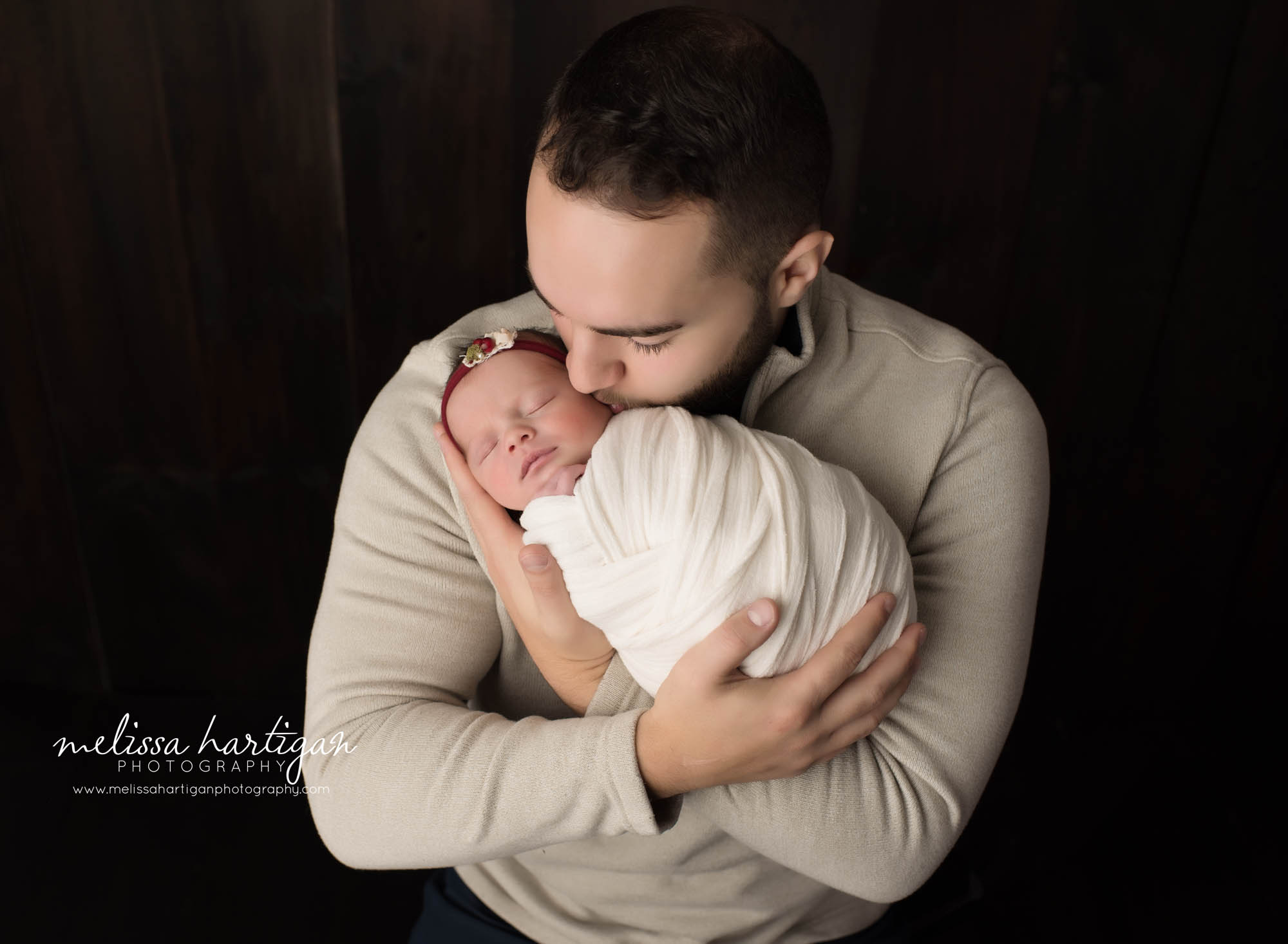 dad holding baby daughter wrapped parents pose