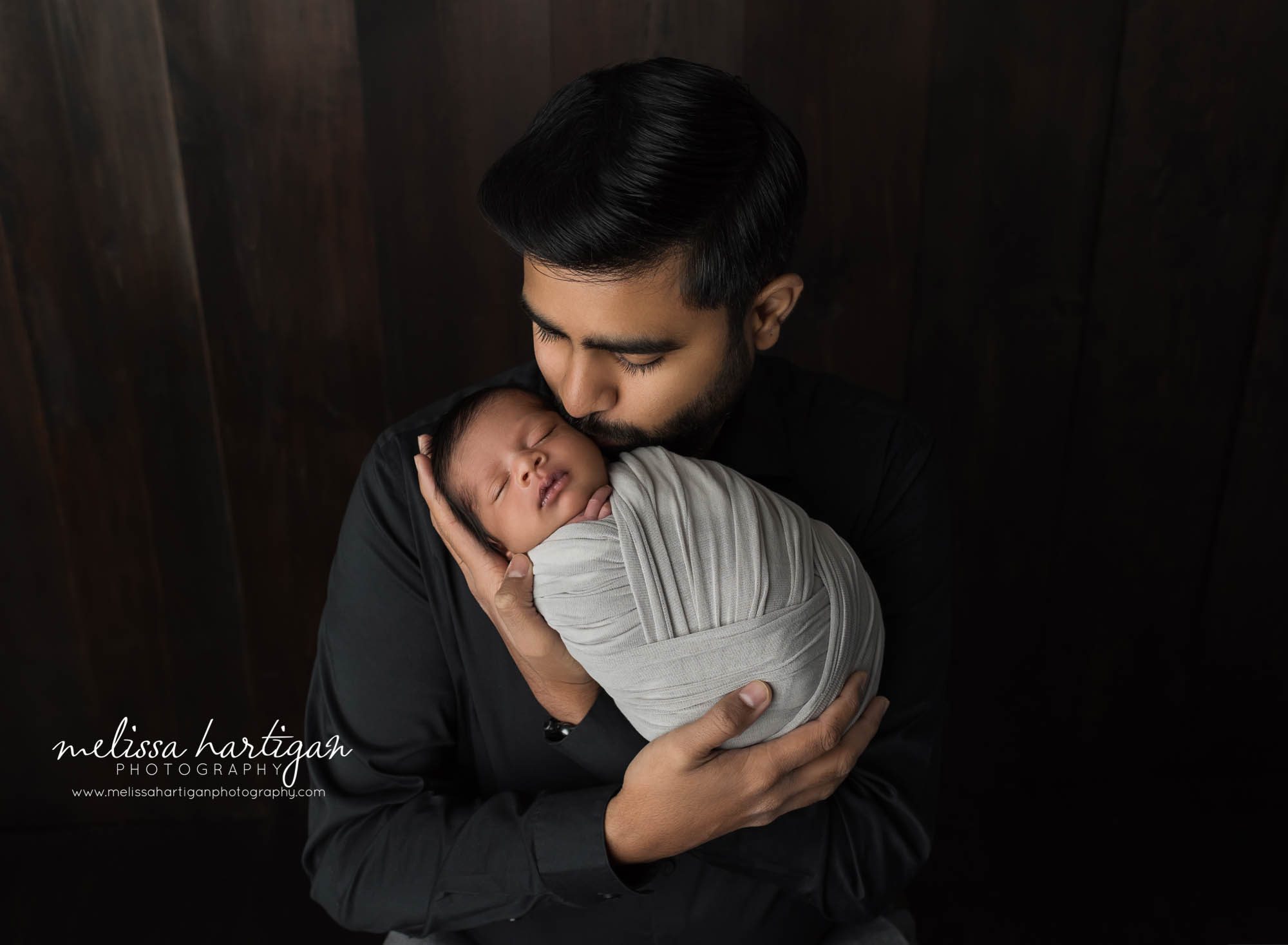 dad holding newborn son in parent pose newborn photography windsor locks