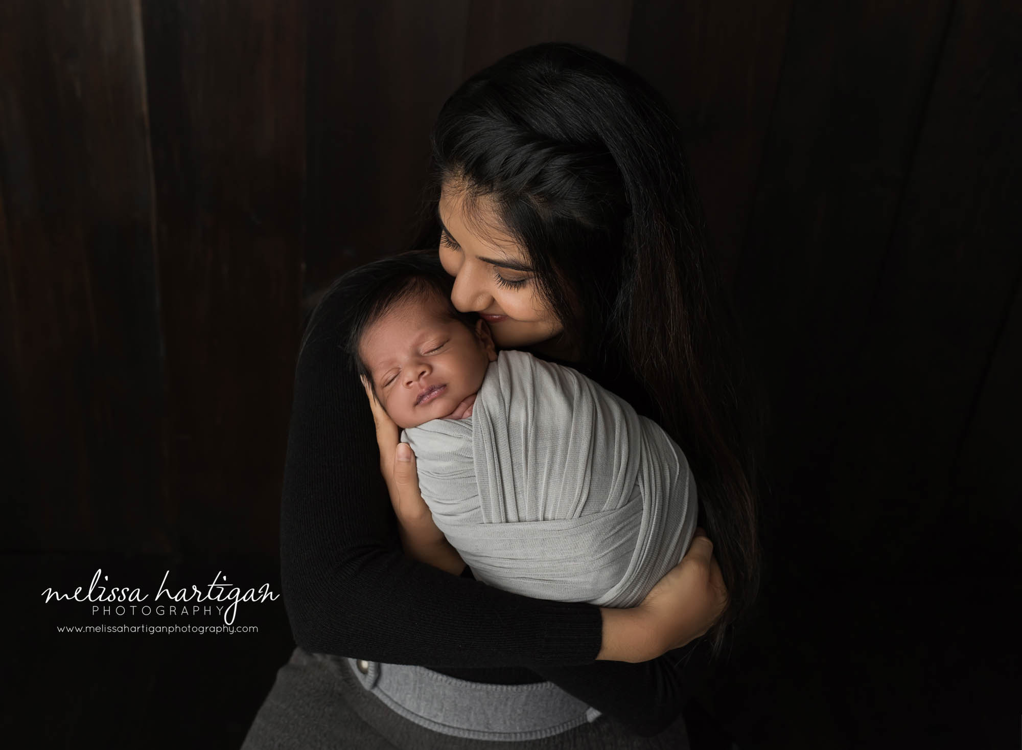 mom kissing newborn son in parent pose newborn photography windsor locks
