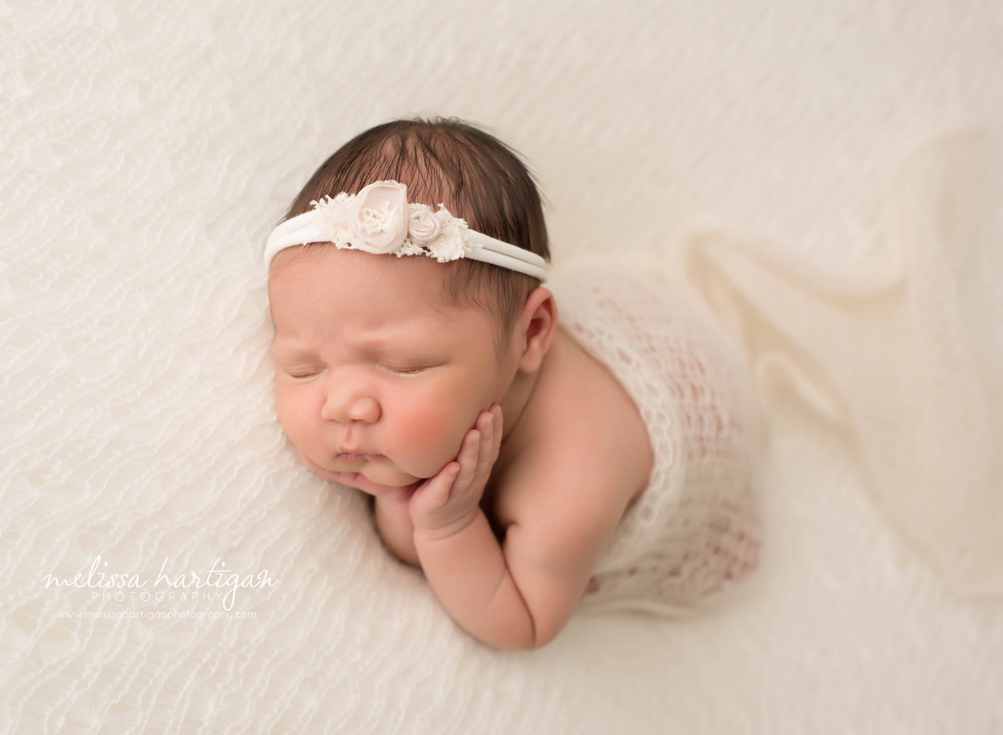 newborn baby girl posed on side with hands under cheeks newborn photography south windsor ct
