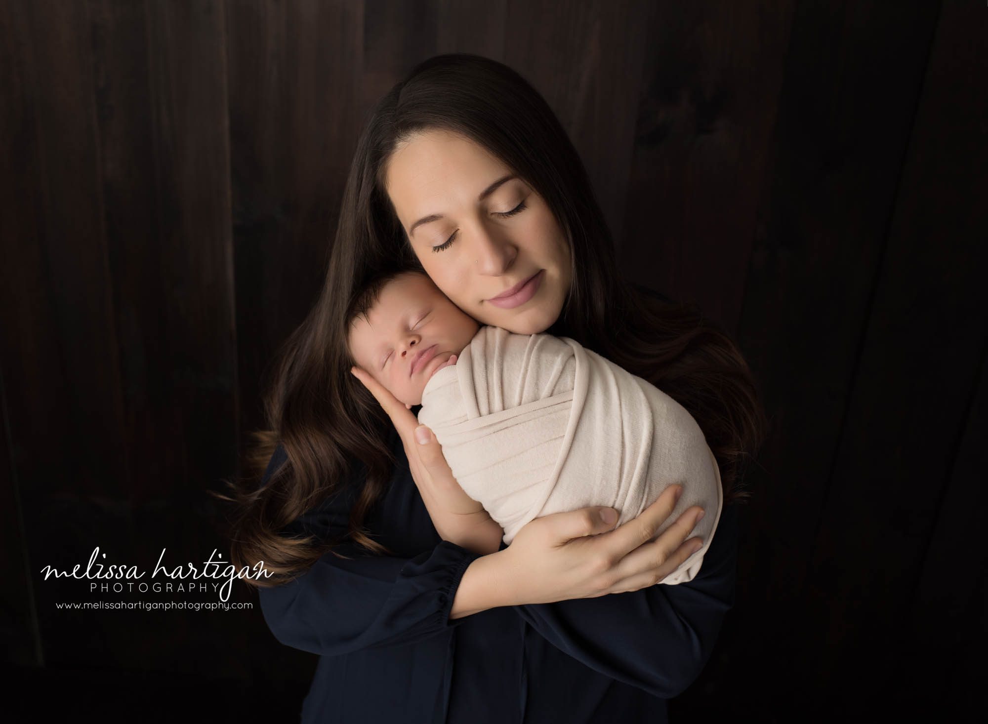 mom holding newborn son wrapped parents pose photoshoot connecticut baby photographer