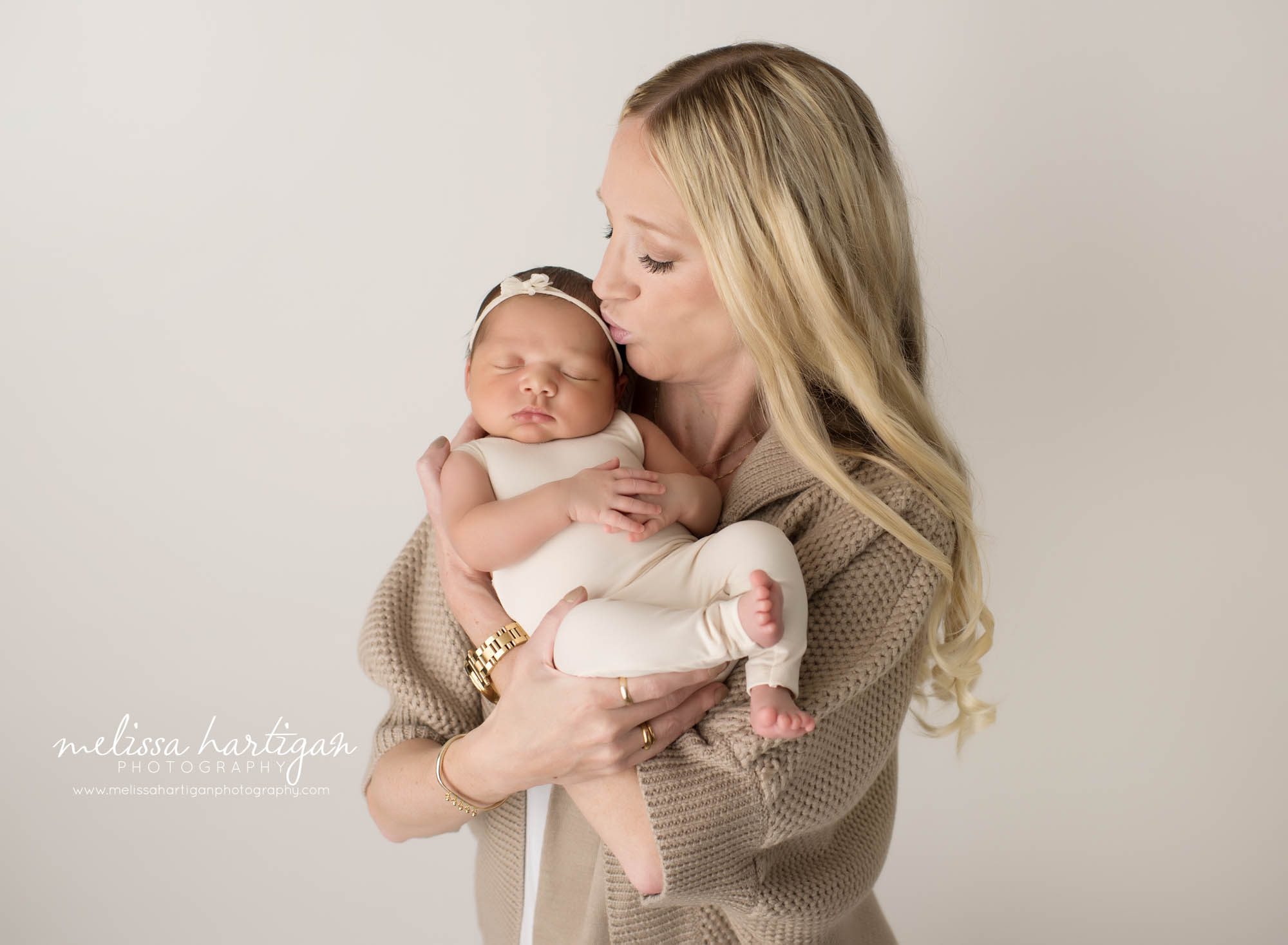 mom holding newborn daughter in parent pose newborn photoshoot connecticut