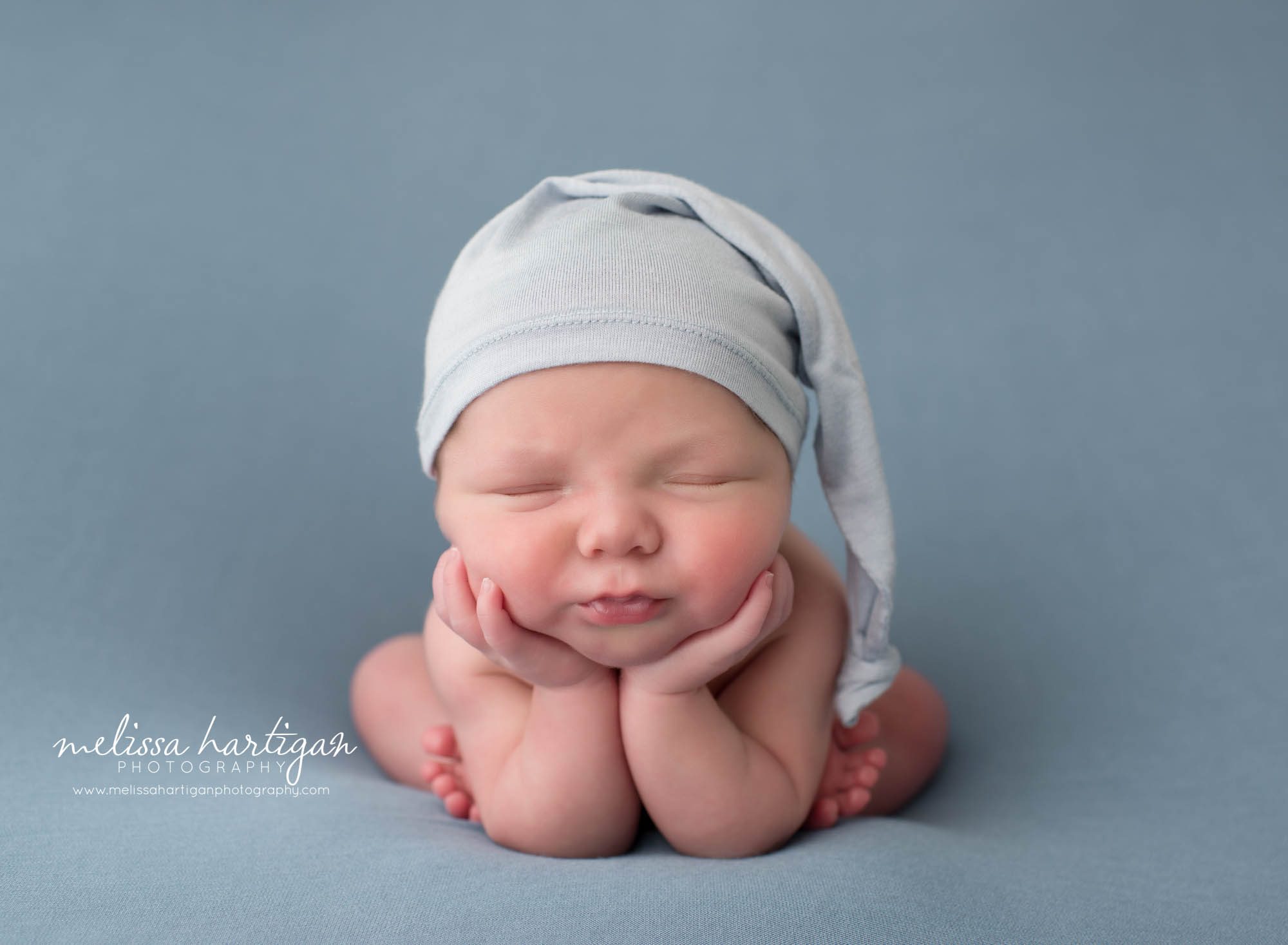 newborn baby boyposed froggy pose on blue backdrop CT twin newborn photography