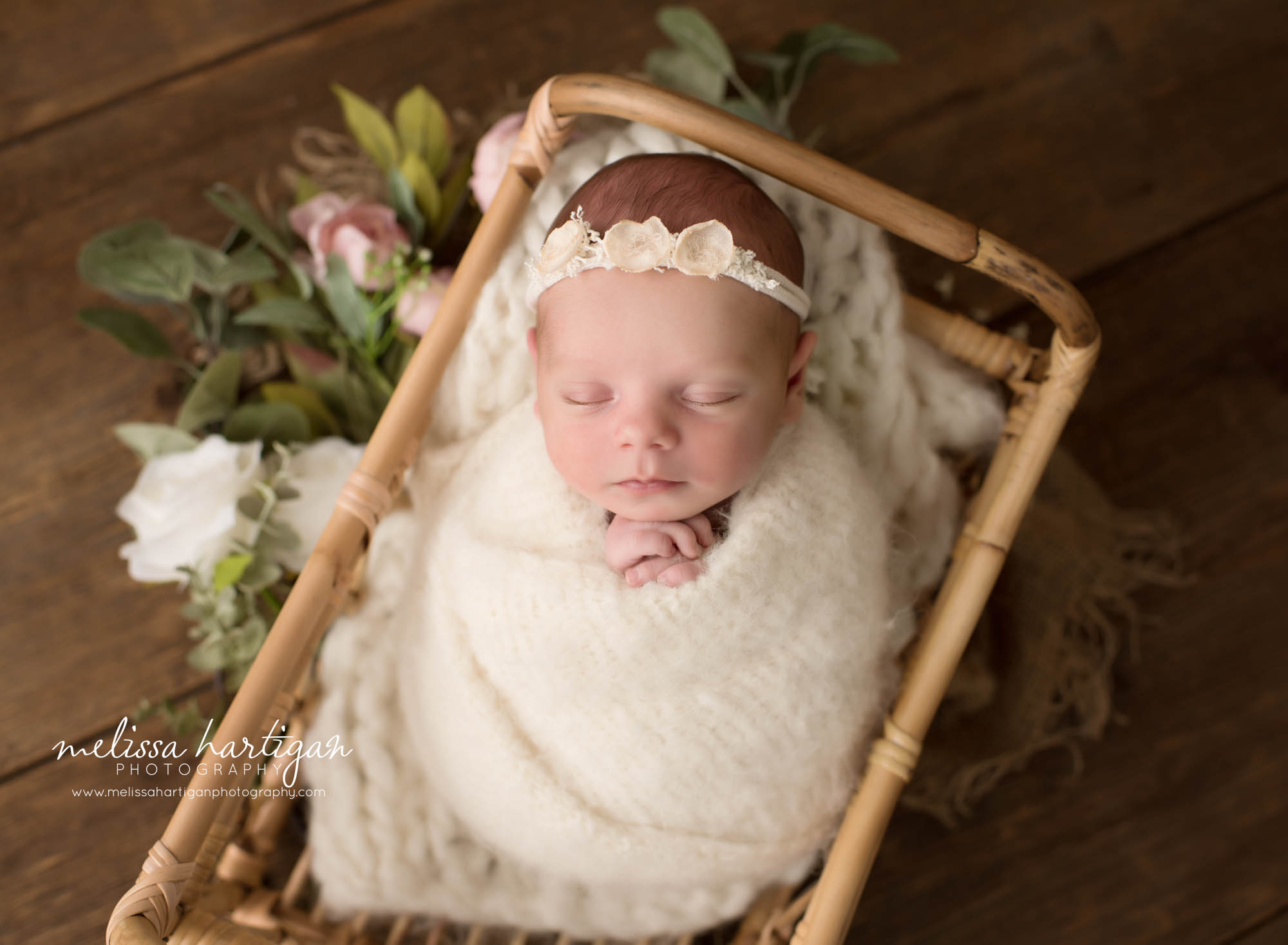 newborn baby girl posed in basket wrapped in cream wrap layer newborn photographer connecticut