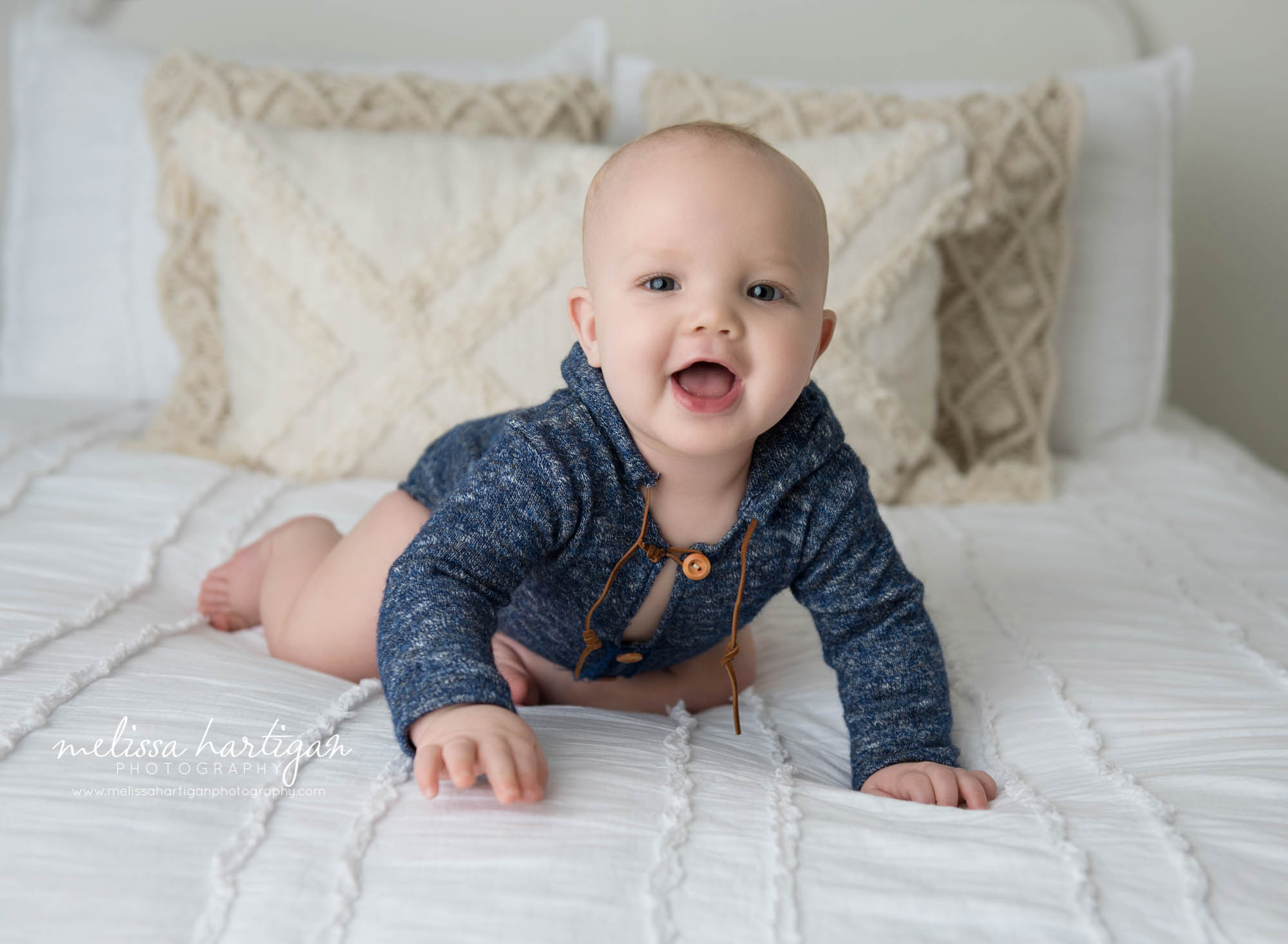 baby boy crawling on bed wearing blue outfit windsor ct baby photography