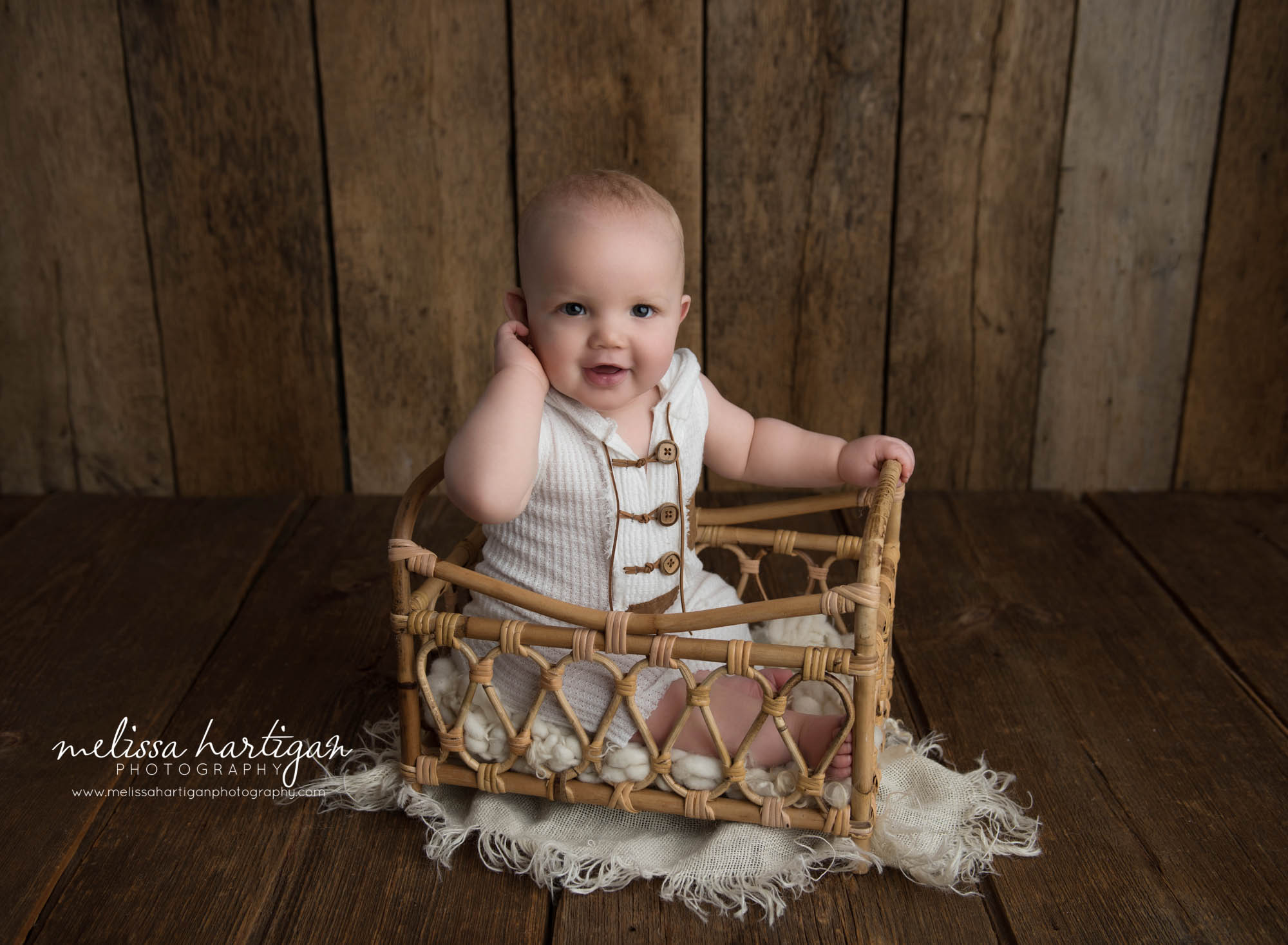 baby boy sitting up on basket in milestone photography ct photoshoot