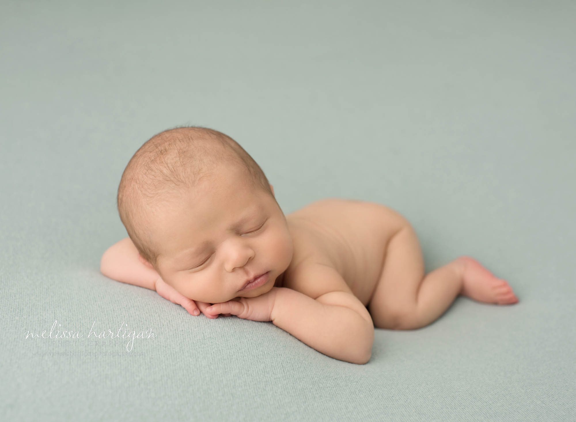 newborn abby boy posed on tummy with cheek resting on hands and fingers connecticut newborn photography tolland county