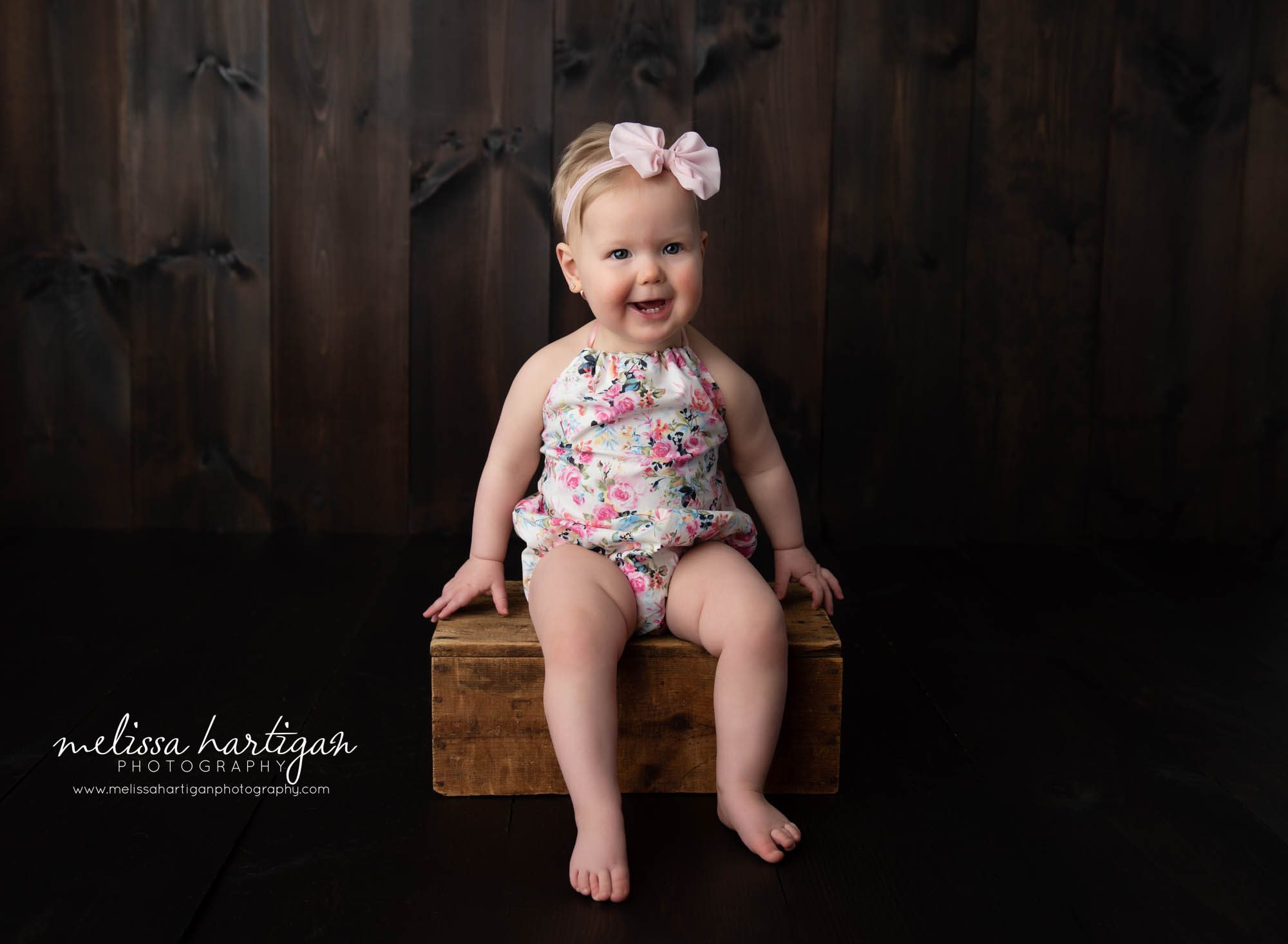 baby girl sitting on crate in baby portrait photoshoot Connecticut baby photographer