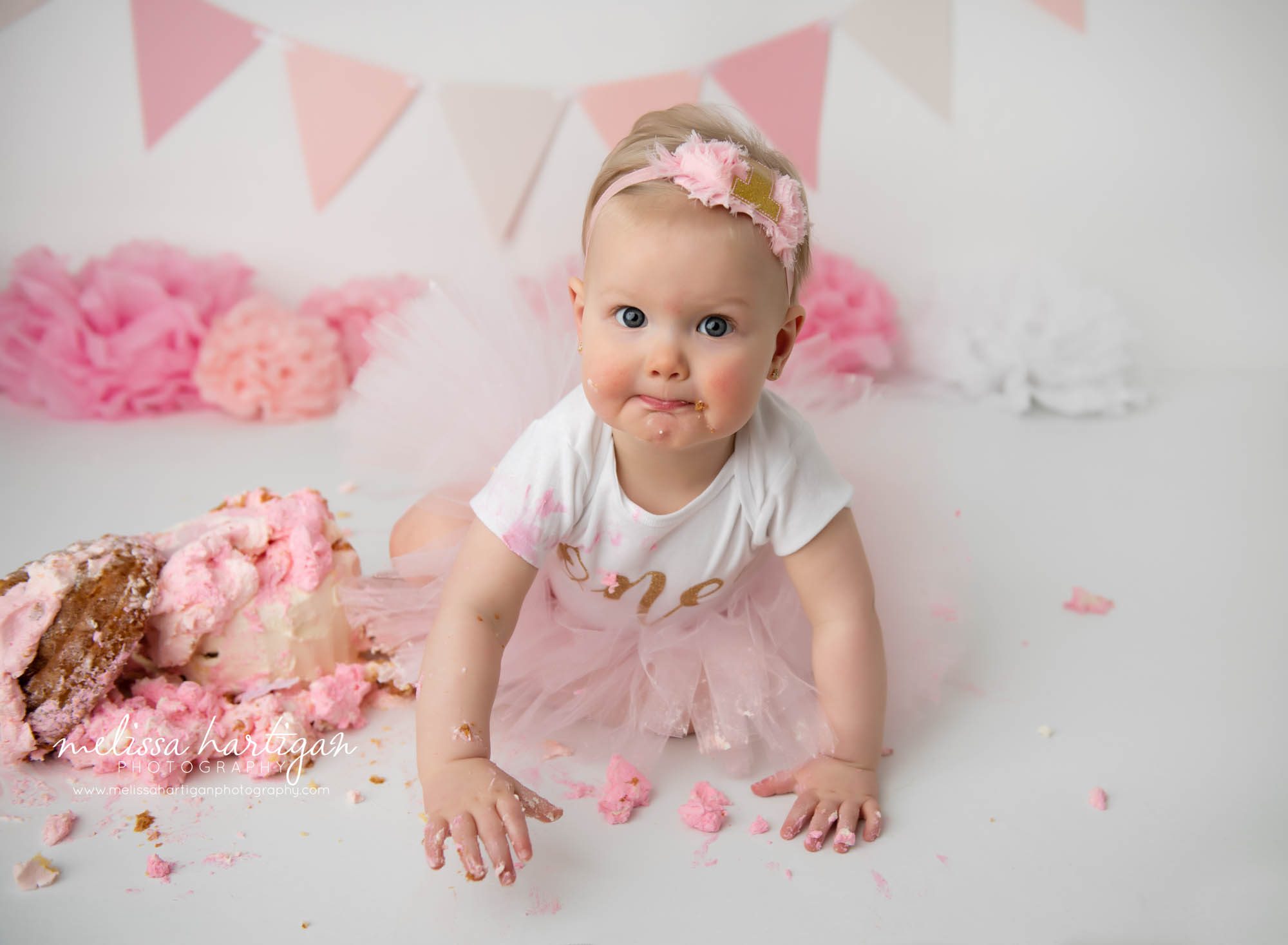 baby girl posing with cake smash cake connecticut baby photographer