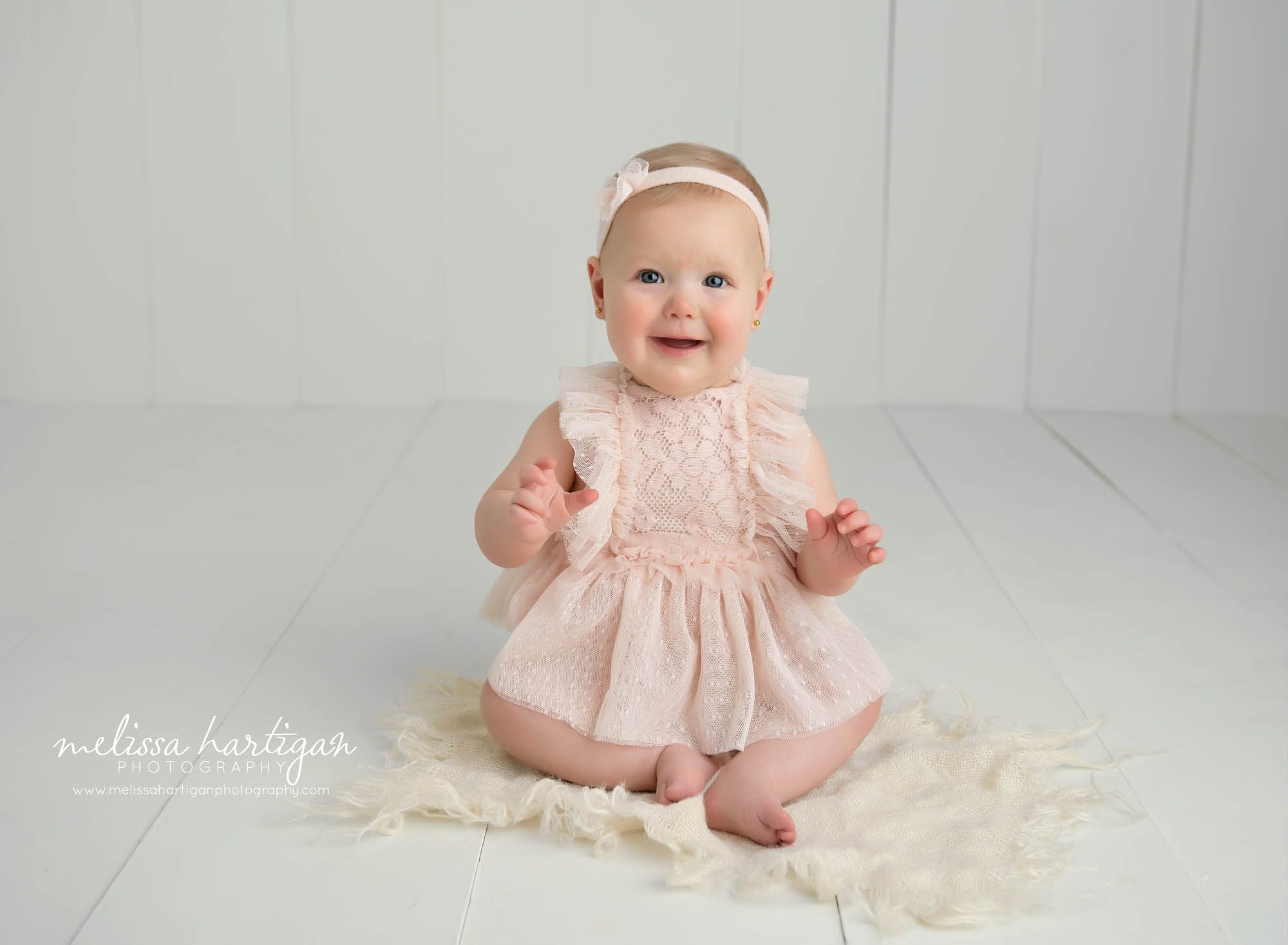 baby girl sitting on floor in photography studio smiling happy windsor ct baby photography