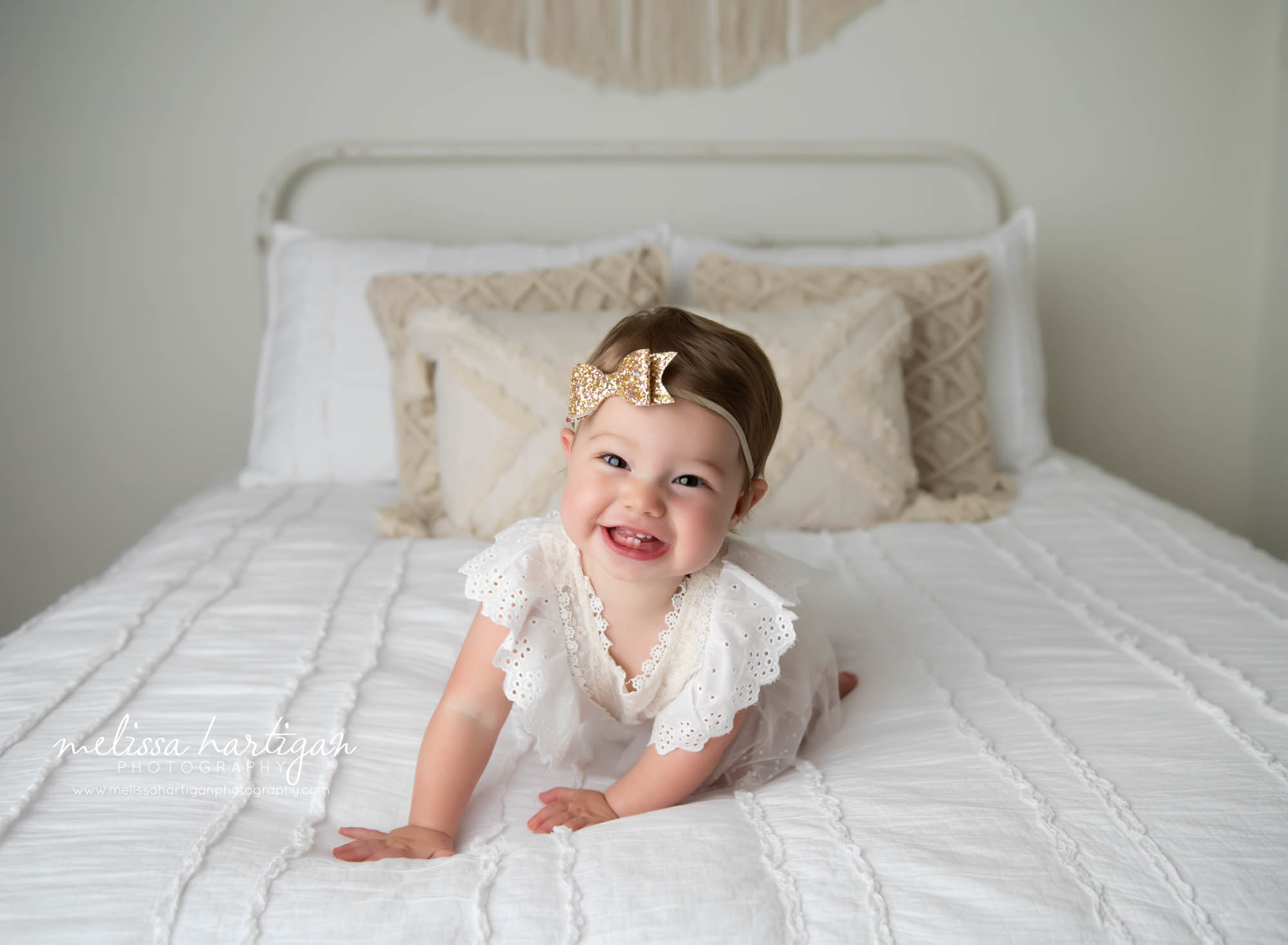 baby girl happy smiling laughing crawling on bed in CT photography studio