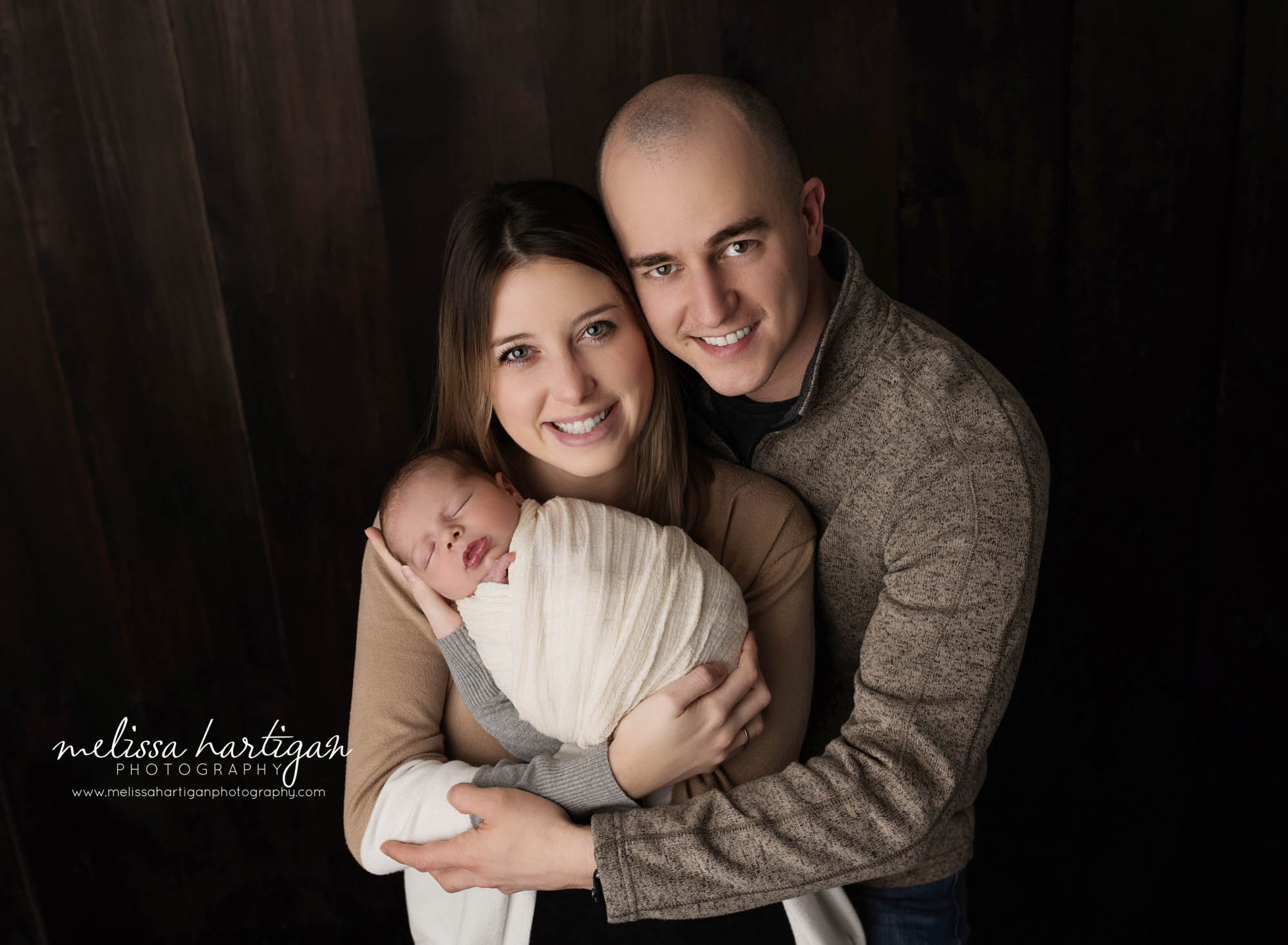 mom dad and newborn baby boy posing together for family photo baby photography photoshoot connecticut studio