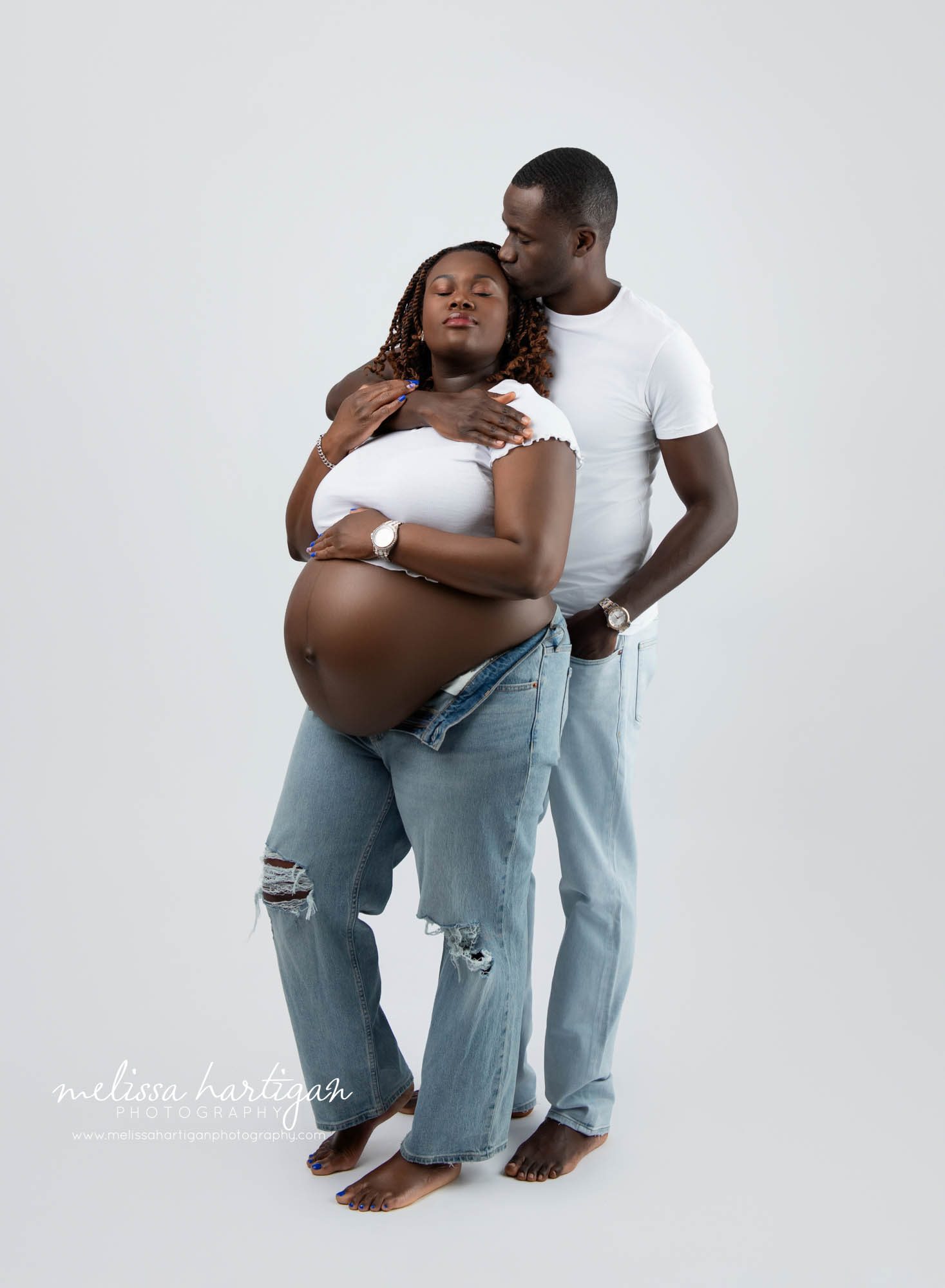 dad kissing mom on forehead in maternity session Maternity Photography Hartford County