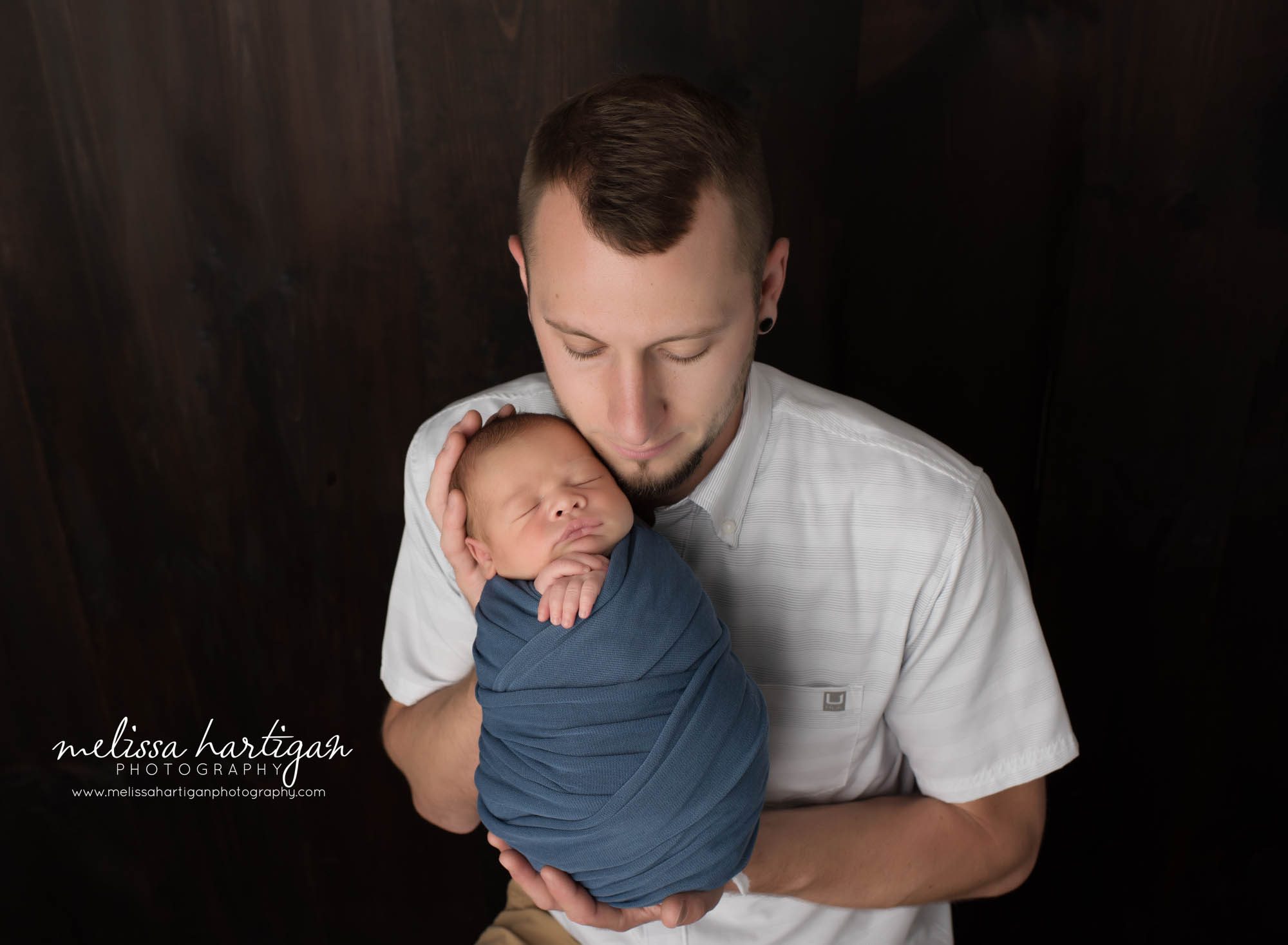 Dad holding newborn son