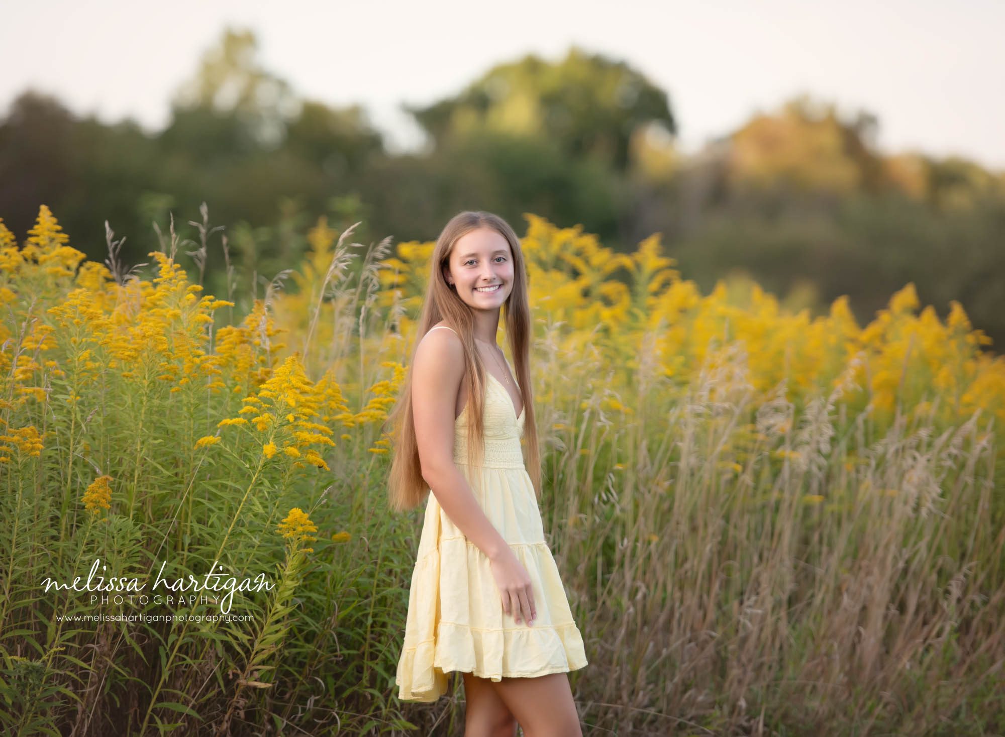 girl wearing yellow dress in senior portrait session