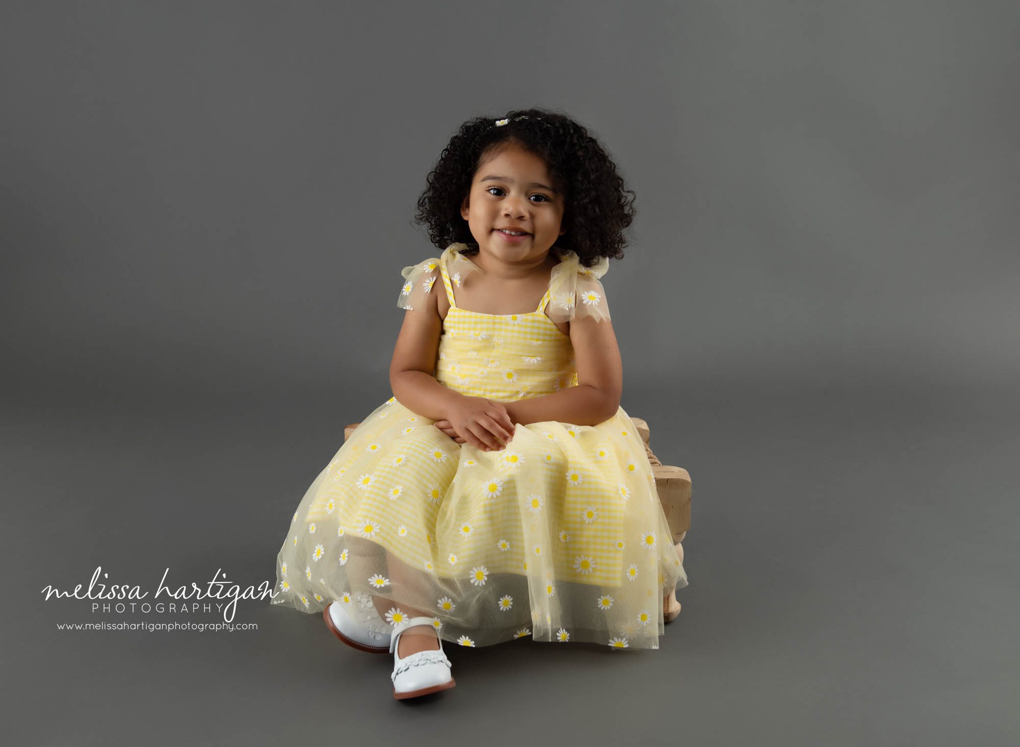 Little girl sitting on prop in studio session