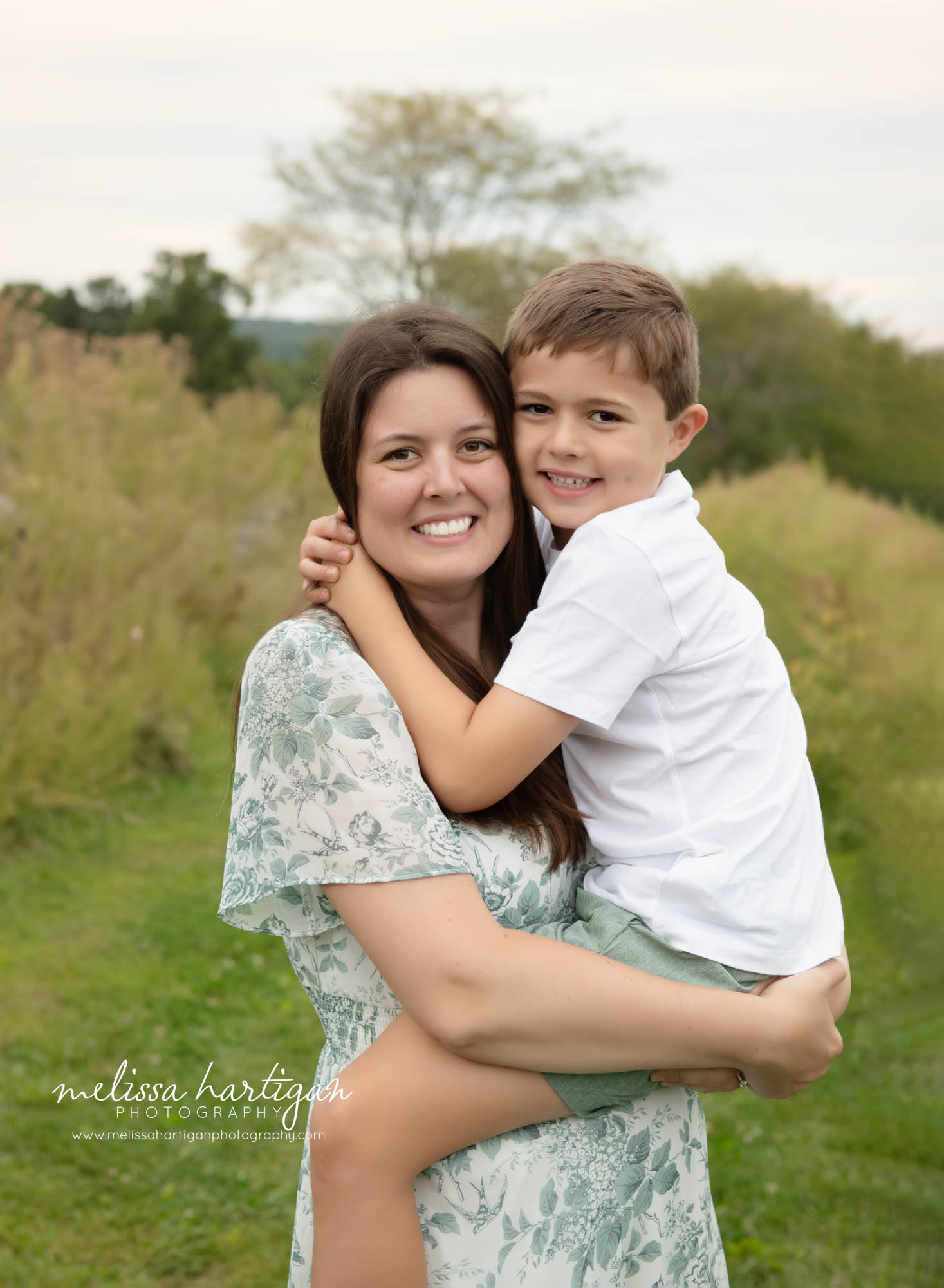 mom holding older son family photo pose Ellington CT Family Photography