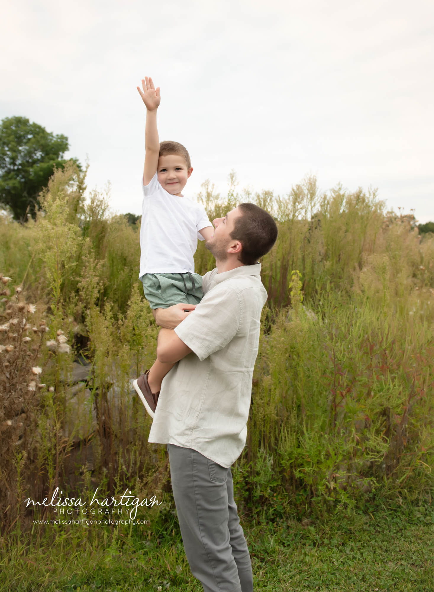 Dad holding happy son