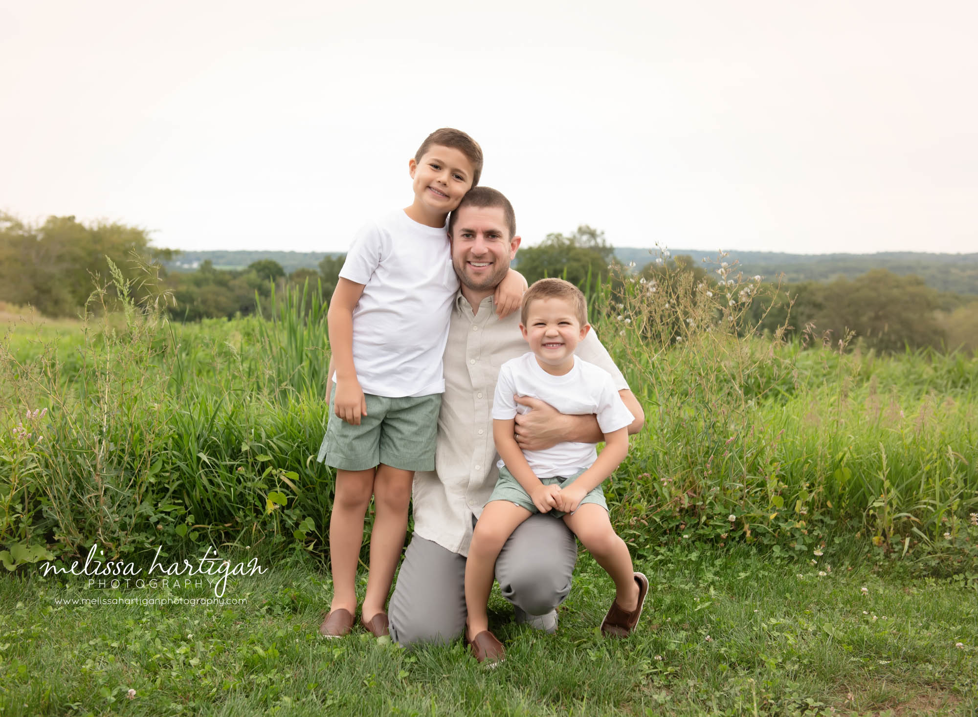 Dad sitting with two sons