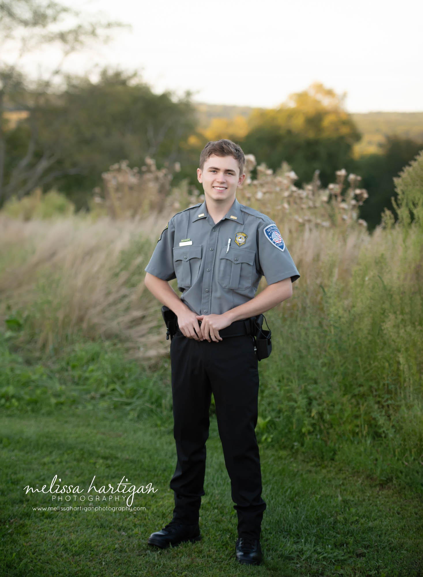 Teenage boy wearing police cadet uniform standing pose smiling Senior Photography Chesire CT