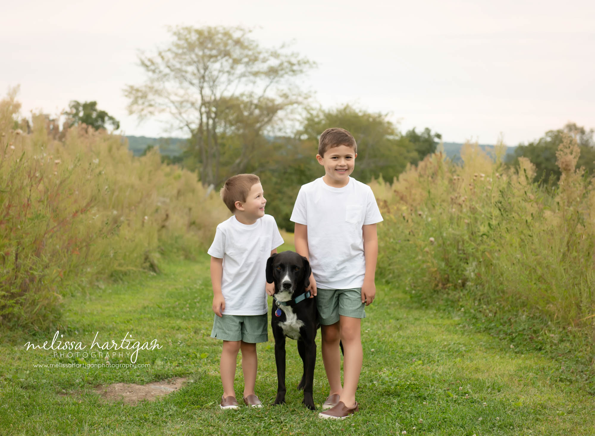 two brothers with family dog family pose outside Ellington CT Family Photography