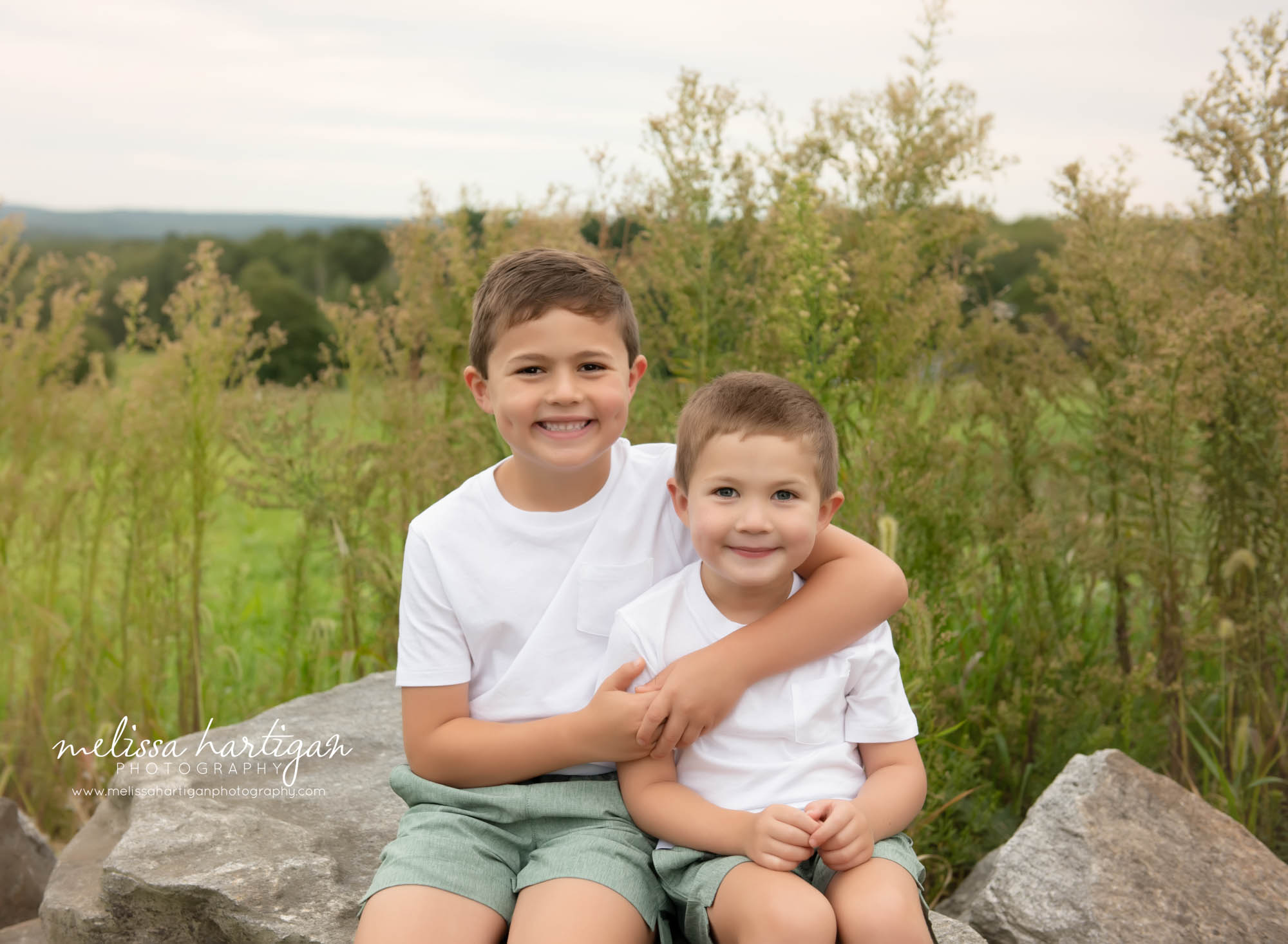 two brothers sitting together happy smiling
