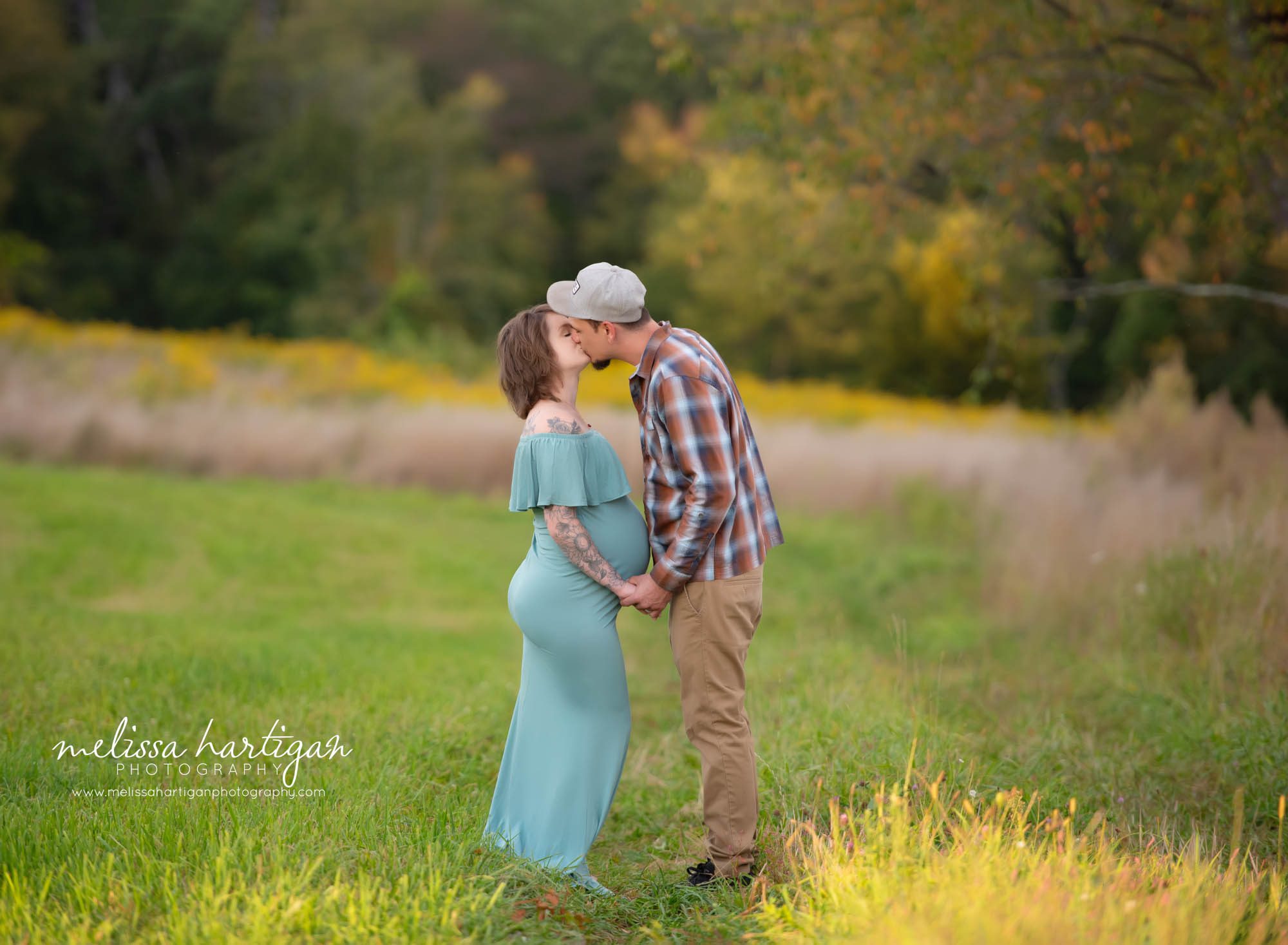 Expectant couple sharing a kiss