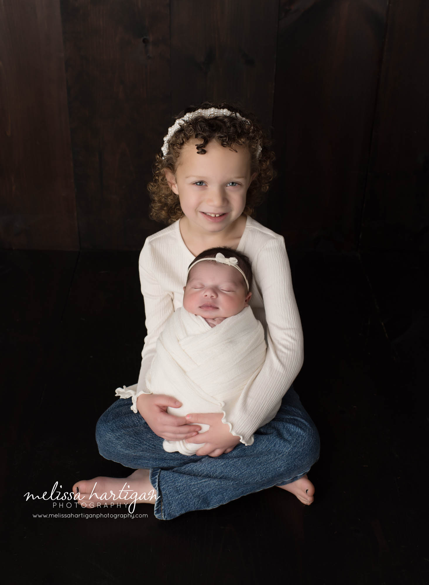 Big sister holding baby sister swaddled Newborn Photography West Hartford