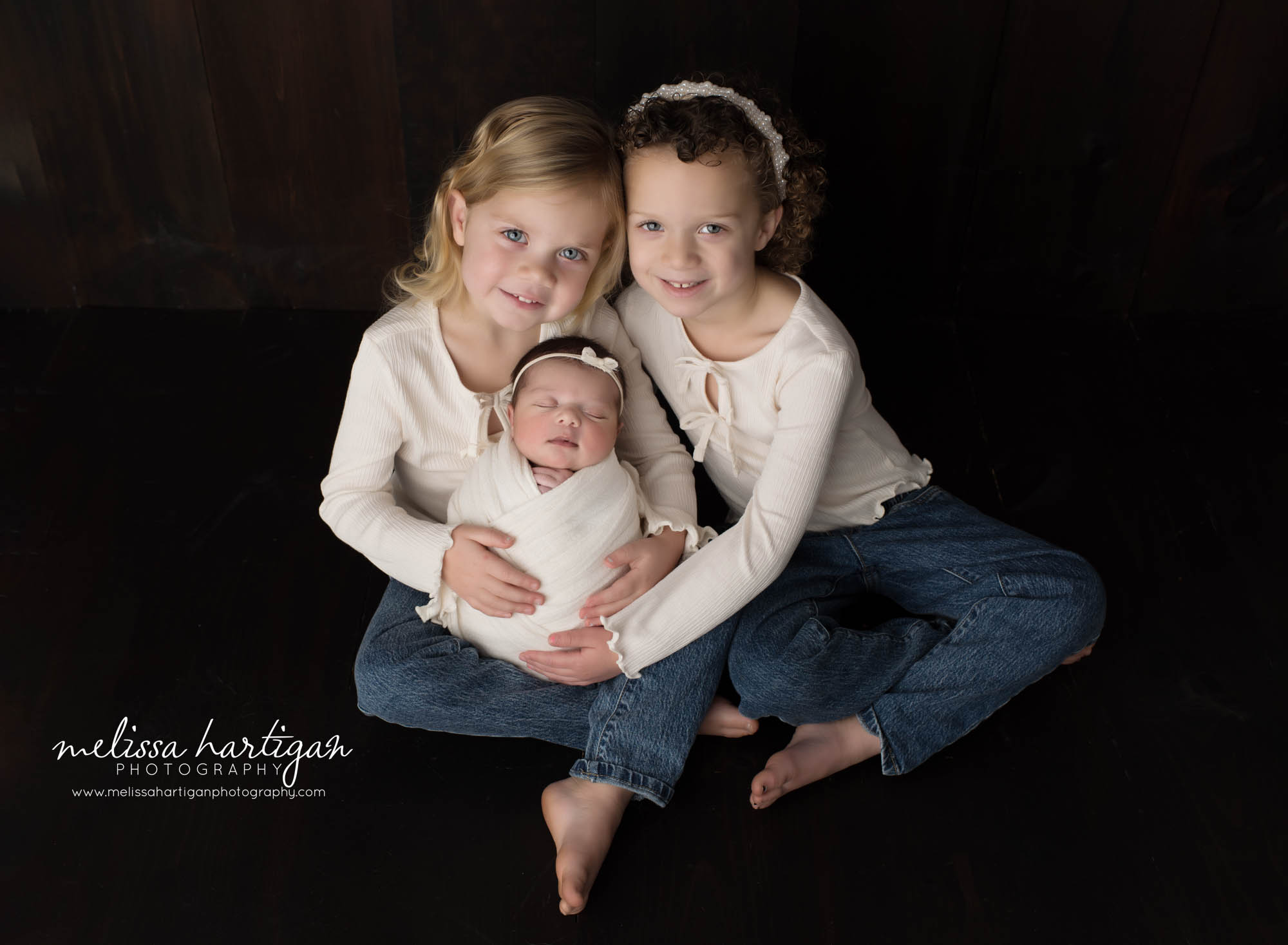 twin sisters holding newborn baby sister in photoshoot Newborn Photography West Hartford