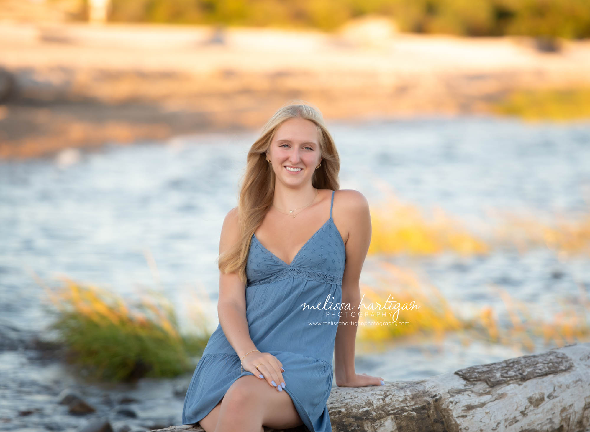 Girl sitting on log at beach happy smiling Northford CT Senior Photography