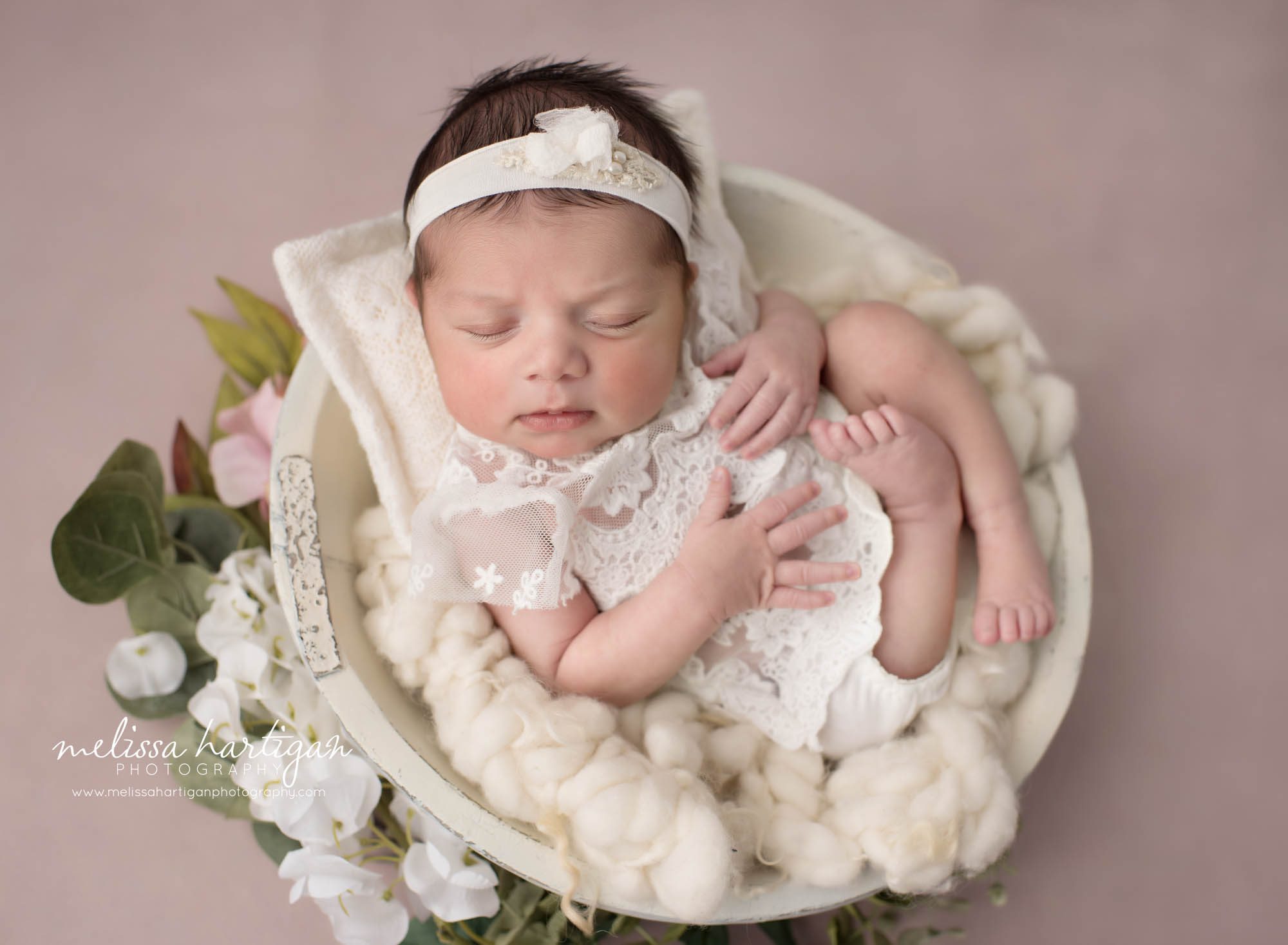newborn baby girl posed in wooden bowl wearing white baby girl outfit with lace Newborn Photography West Hartford