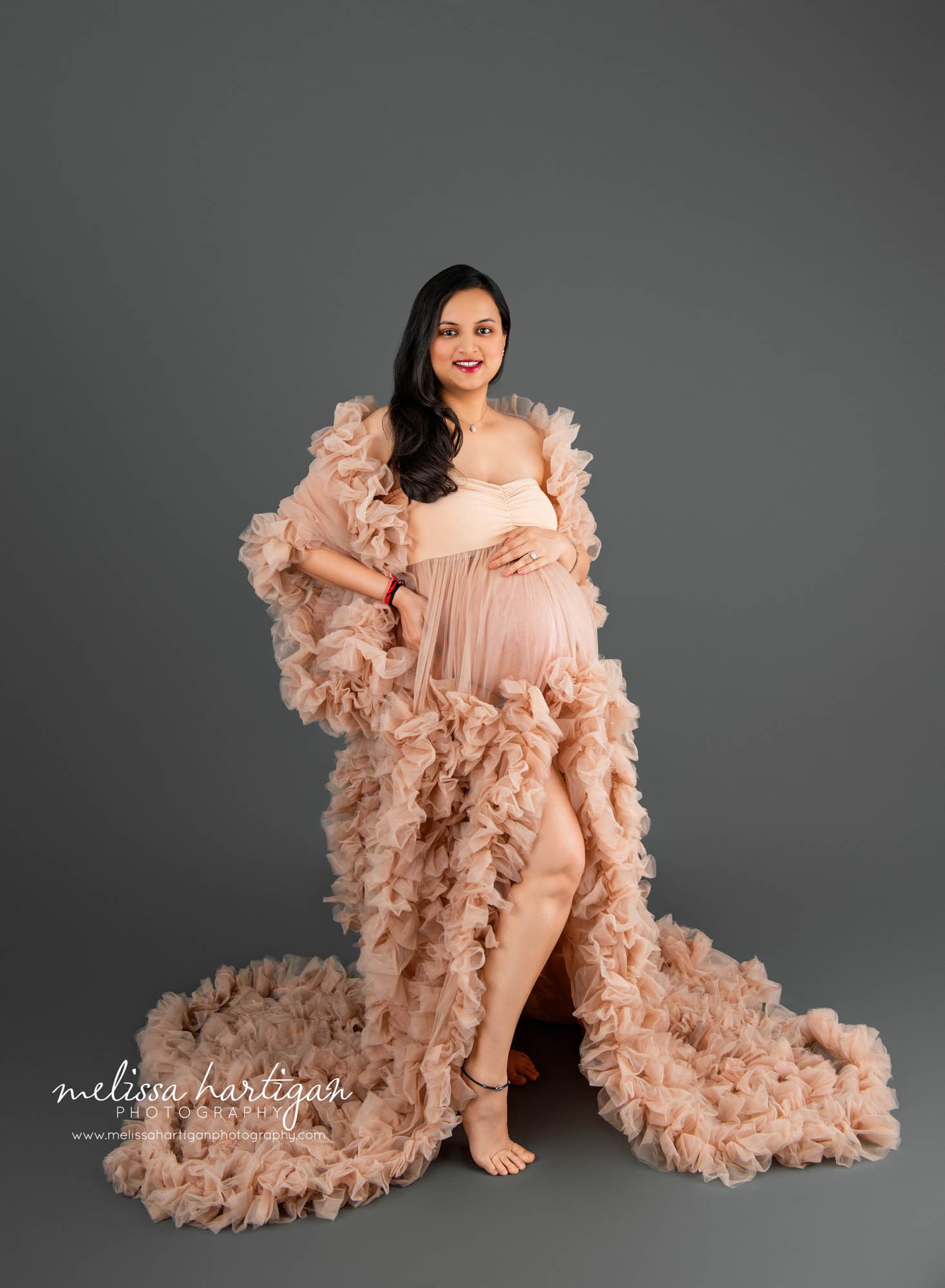 Pregnant mom wearing ruffled couture maternity gown in beige color Maternity Photography South Windsor