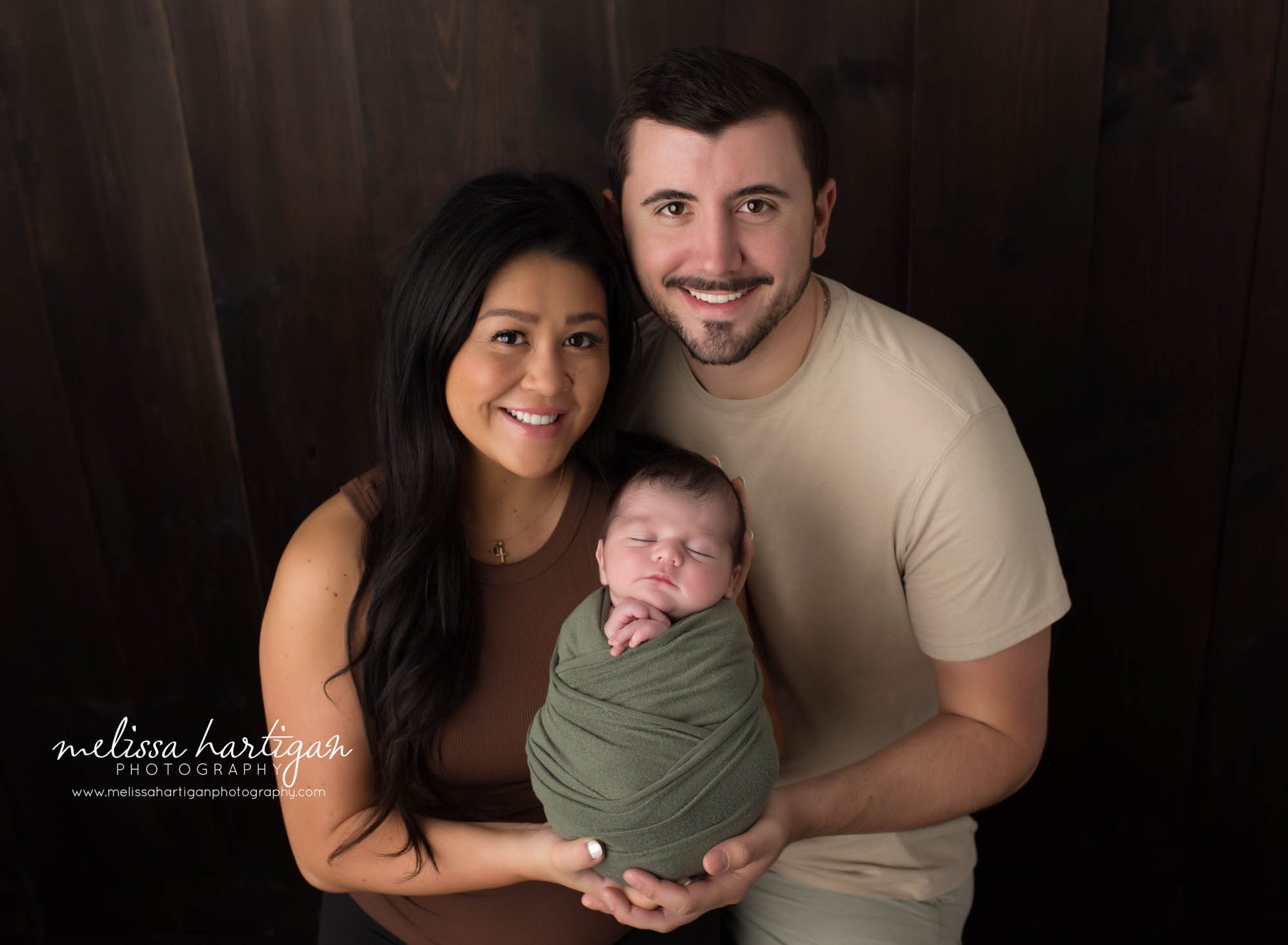 Mom and dad holding their newborn son Newborn Photography Ellington CT