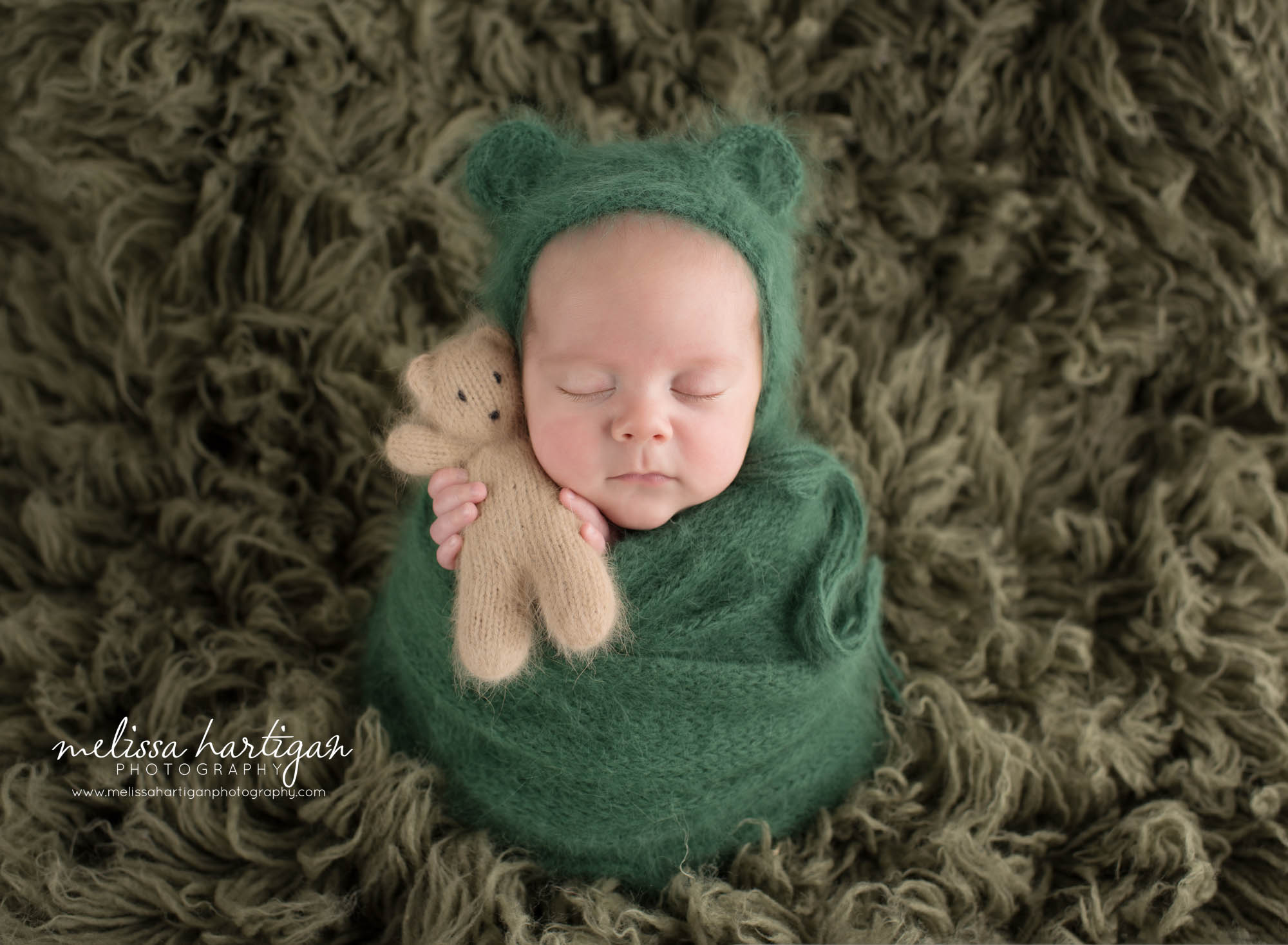 newborn baby boy posed with knitted newborn teddy wearing knitted teddy bear bonnet CT newborn photography