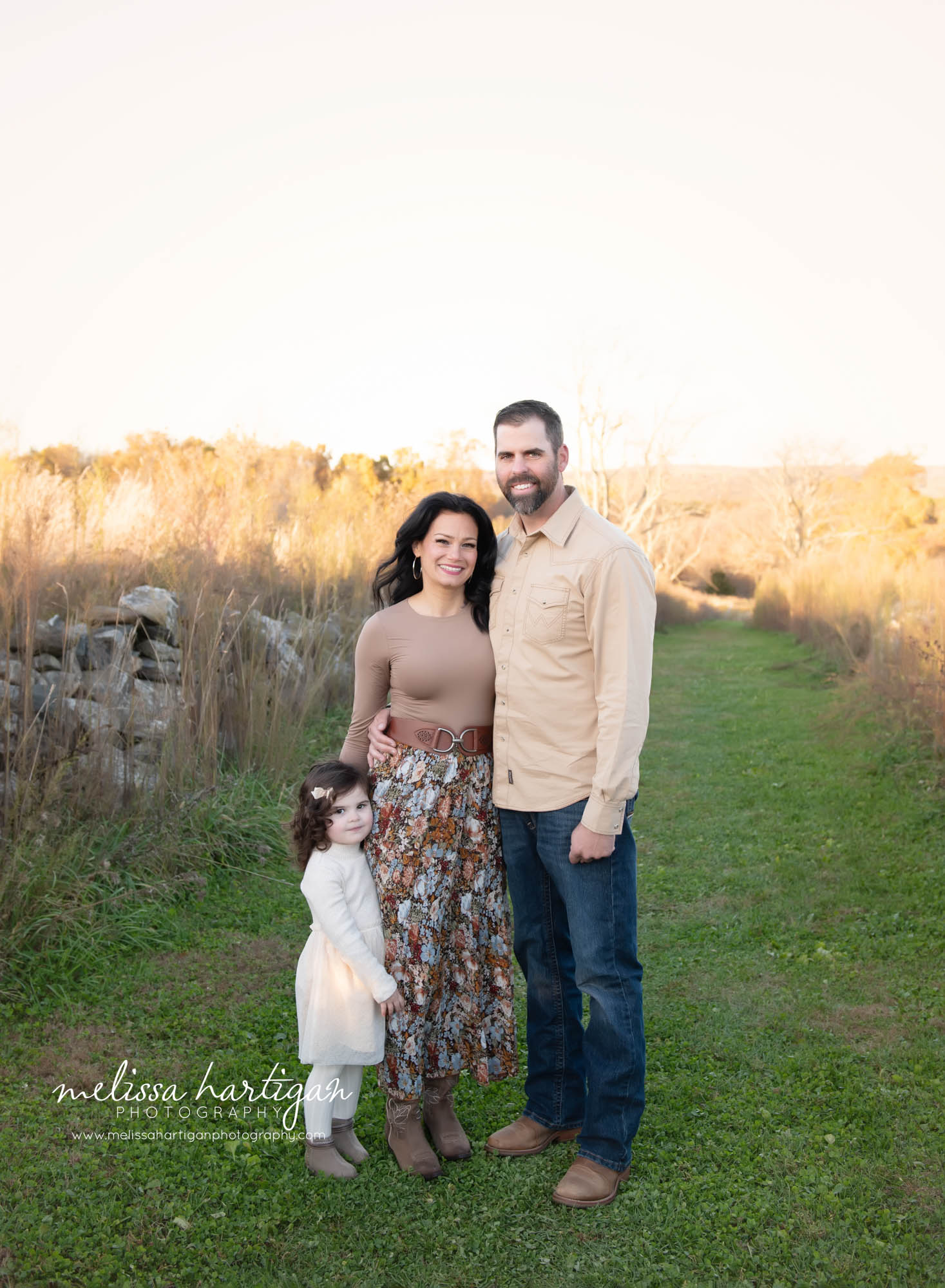 dad mom and daughter posed together for family pose
