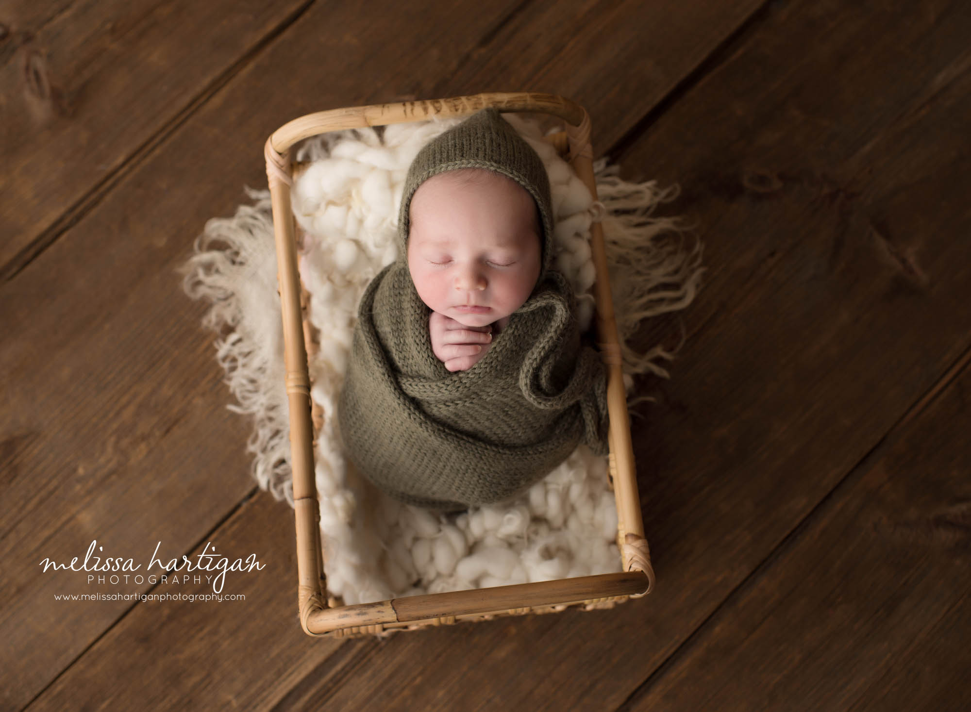newborn baby boy swaddled in knitted green wrap wearing matching bonnet Newborn Photography Portland CT
